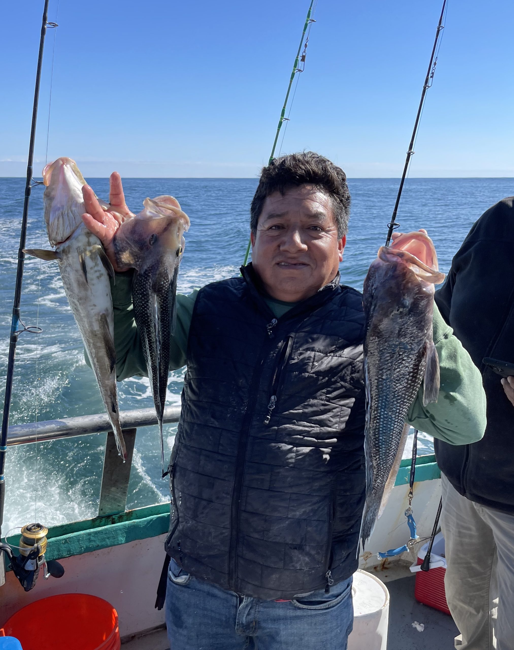 a man holding a fish in the water