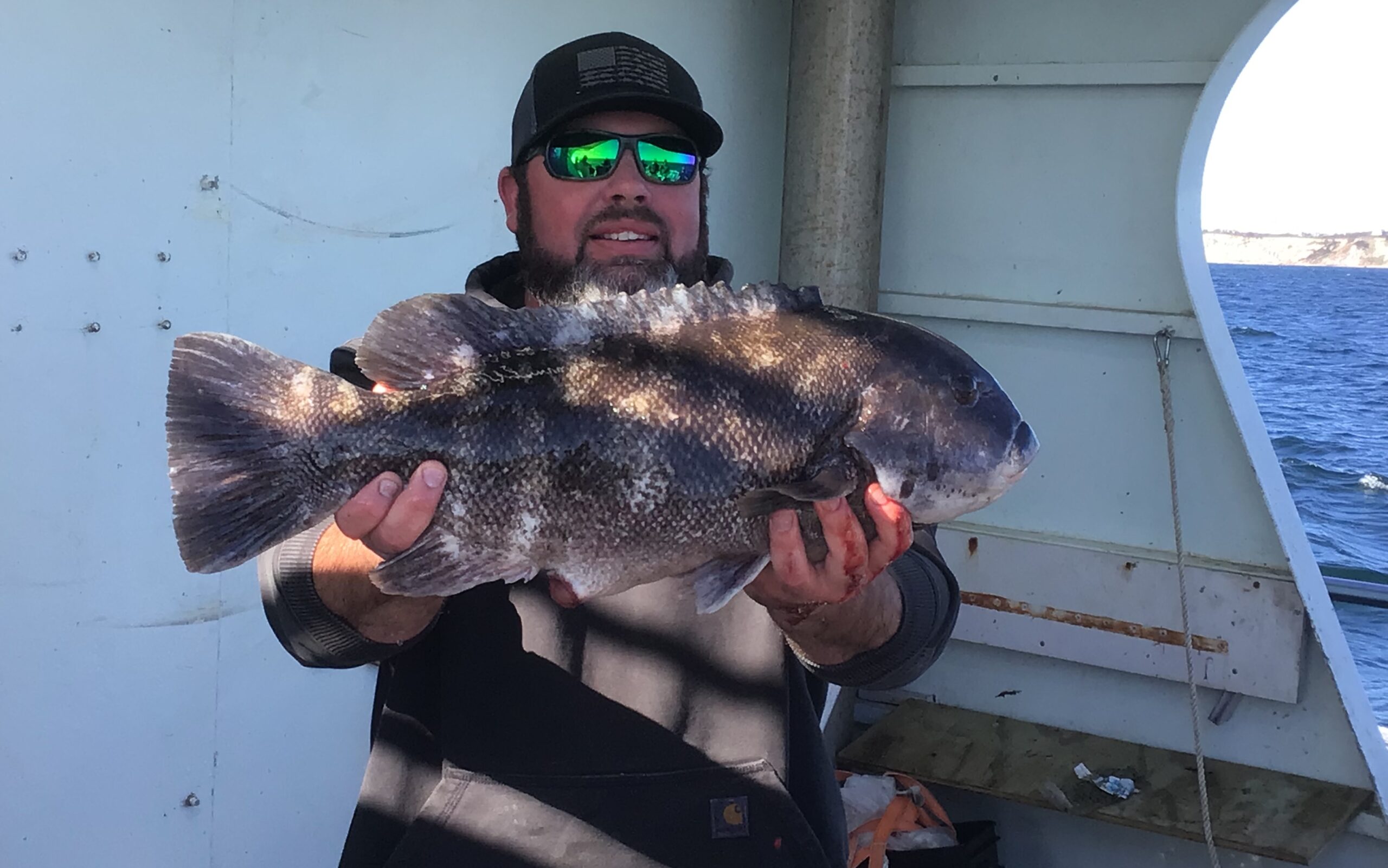 a man holding a fish in the water