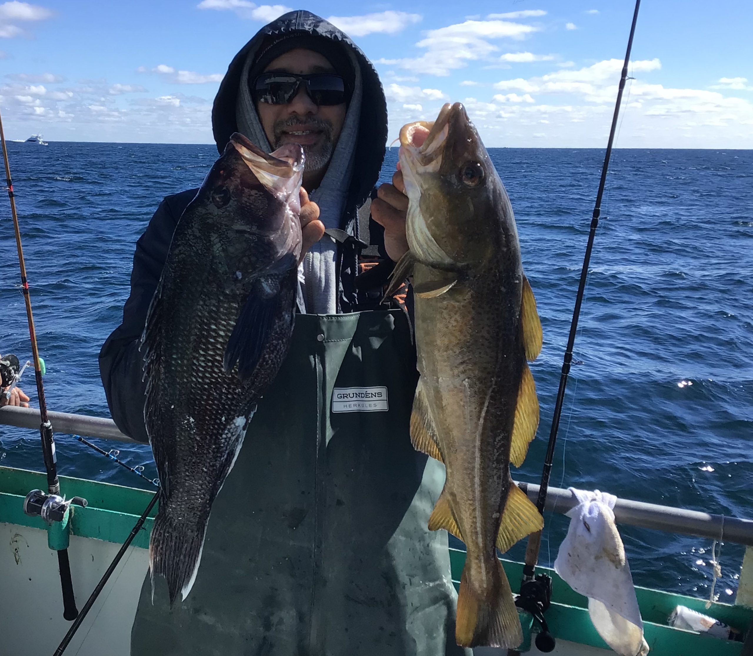 a person holding a fish on a boat in the water