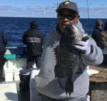 a person holding a fish in the water