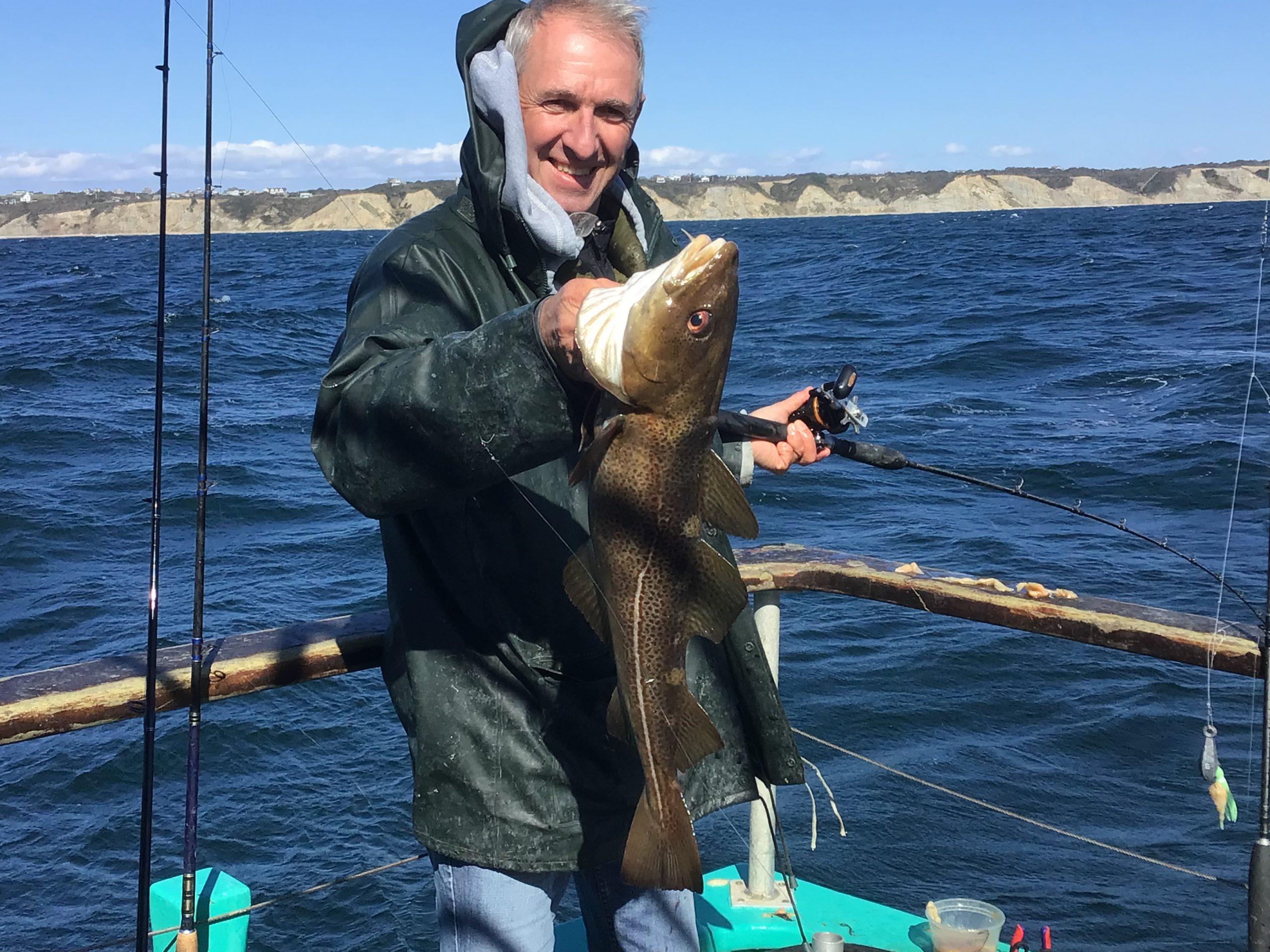 a man holding a fish in the water