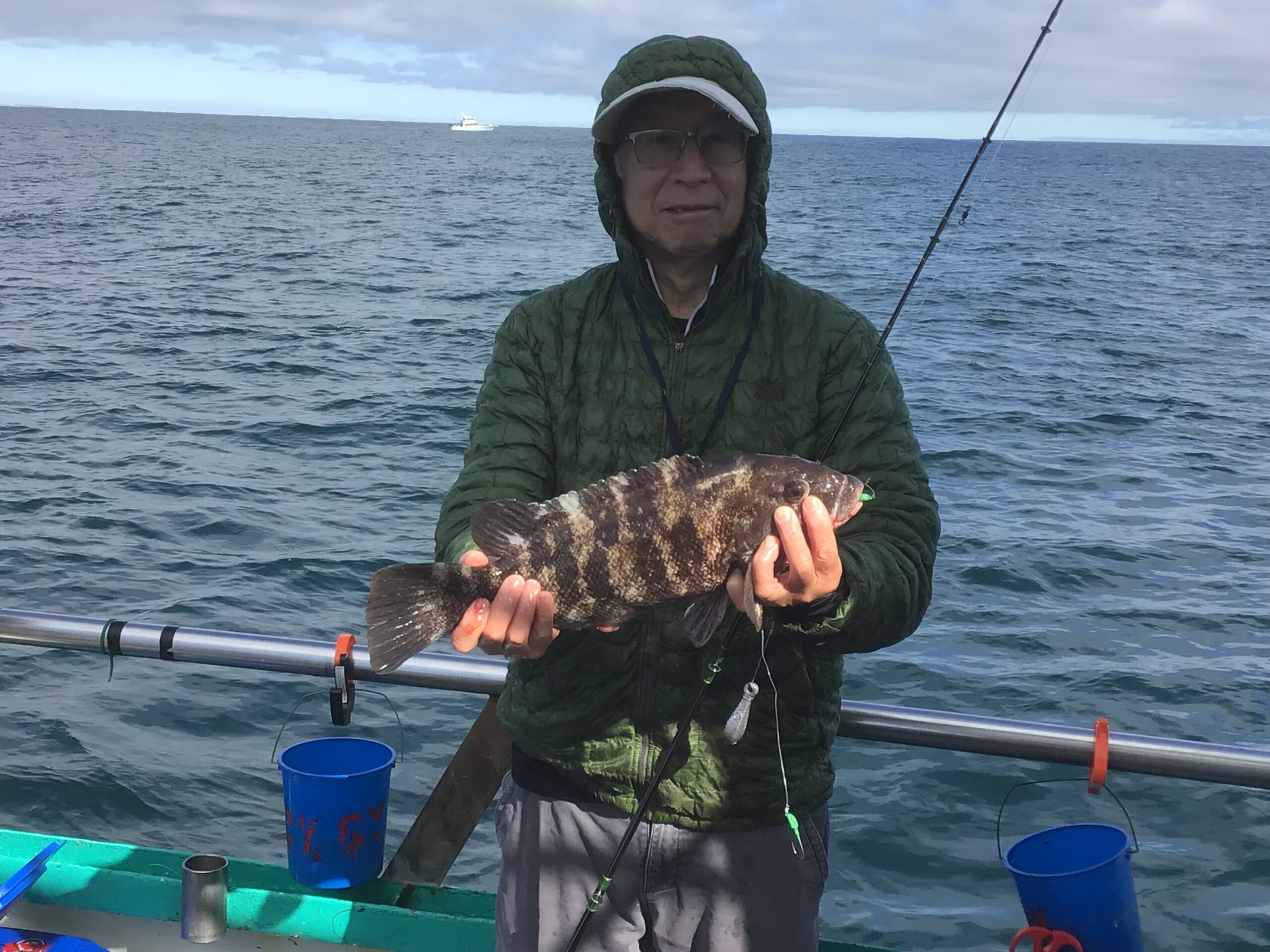 a person holding a fish on a boat in a body of water