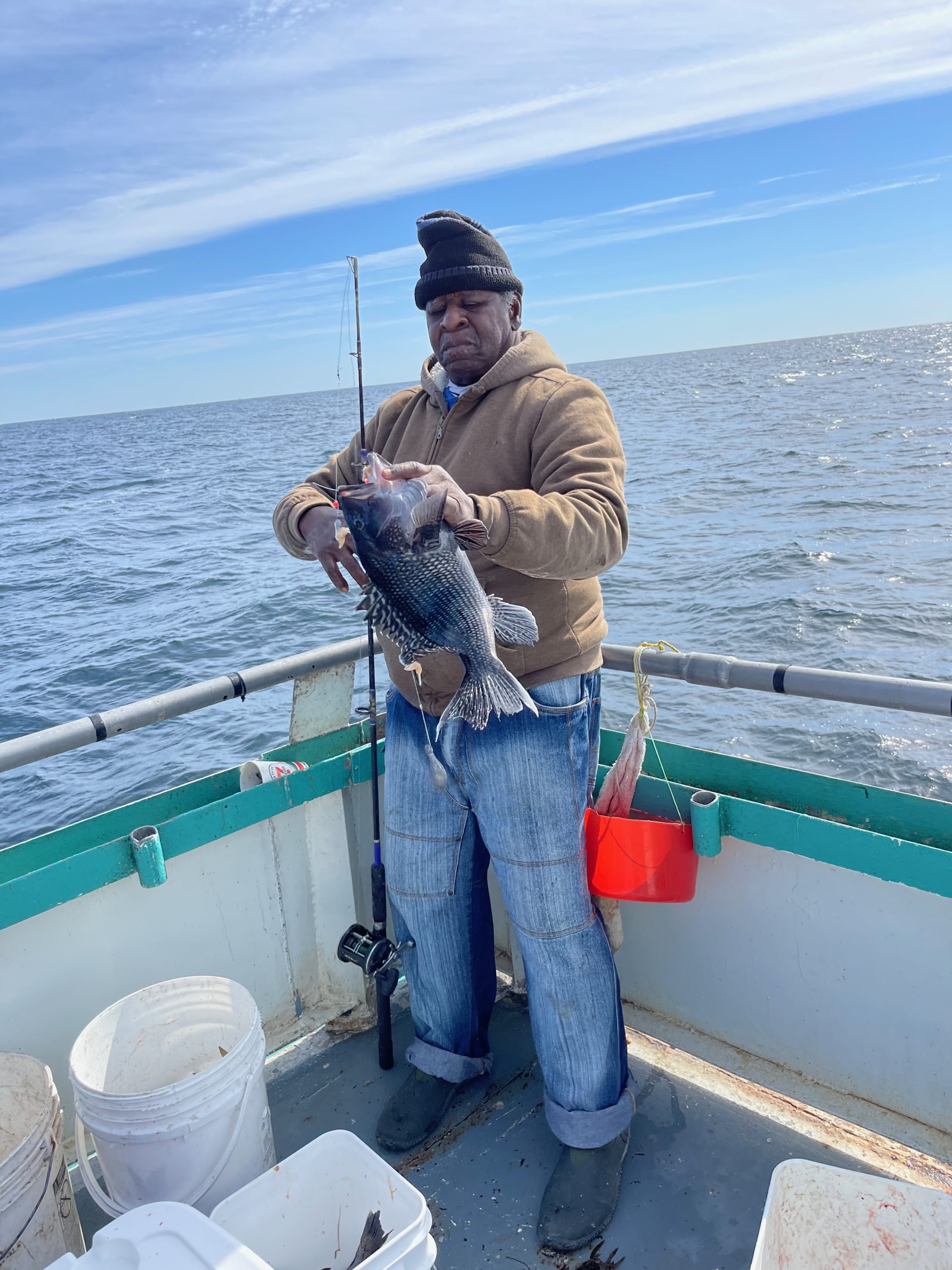 a person standing next to a body of water
