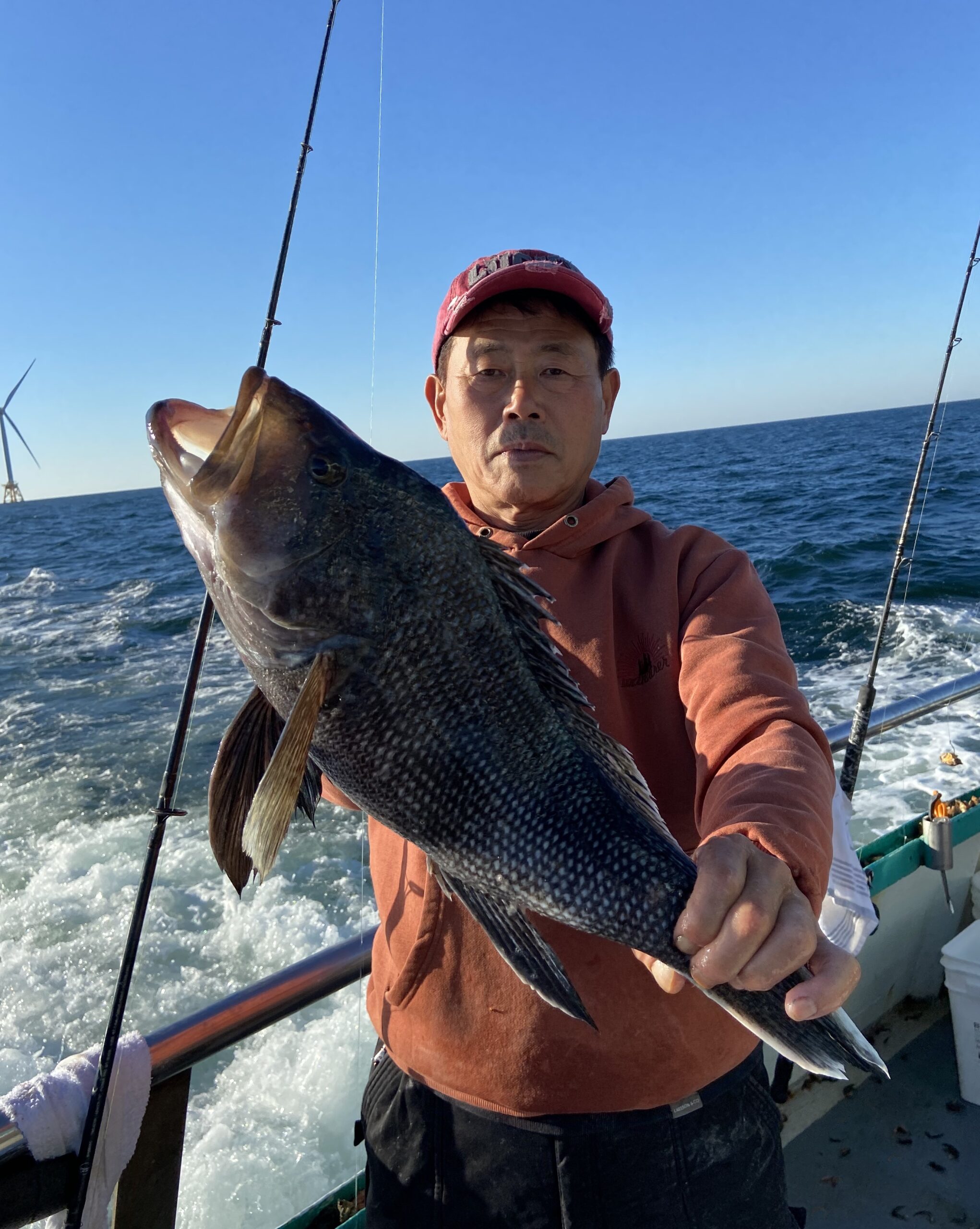 a person holding a fish on a boat in the water