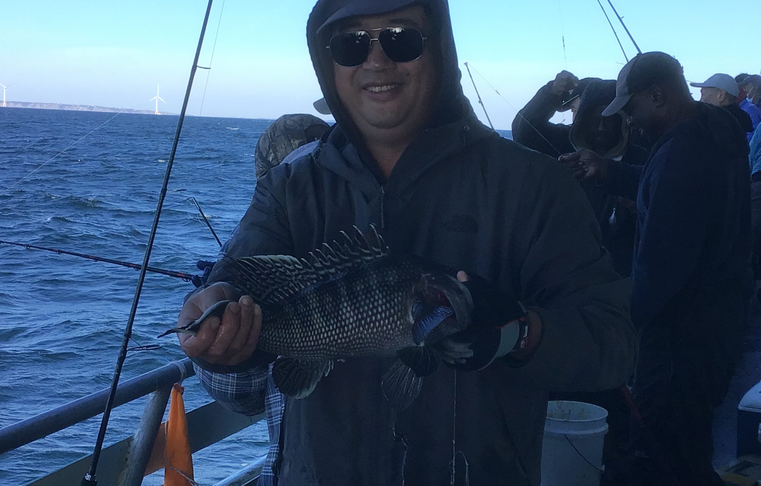 a man holding a fish on a boat