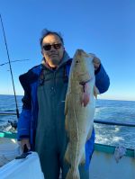 a person holding a fish in the water