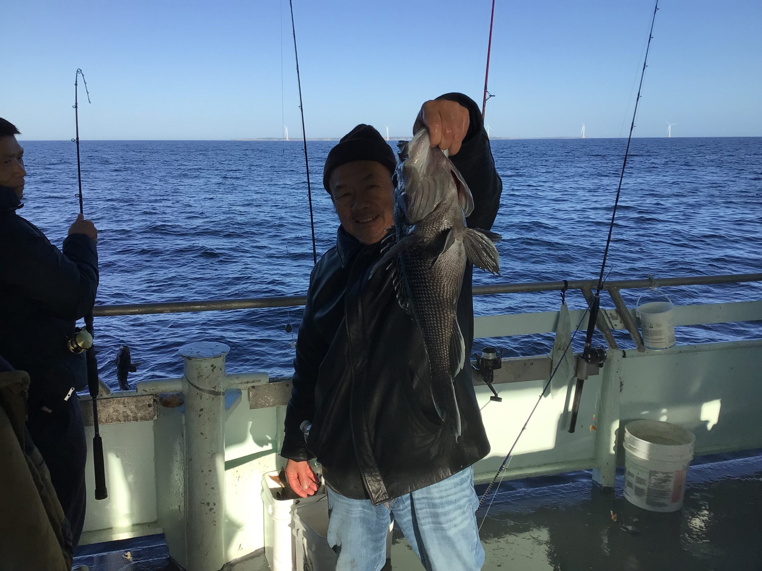 a person standing next to a body of water