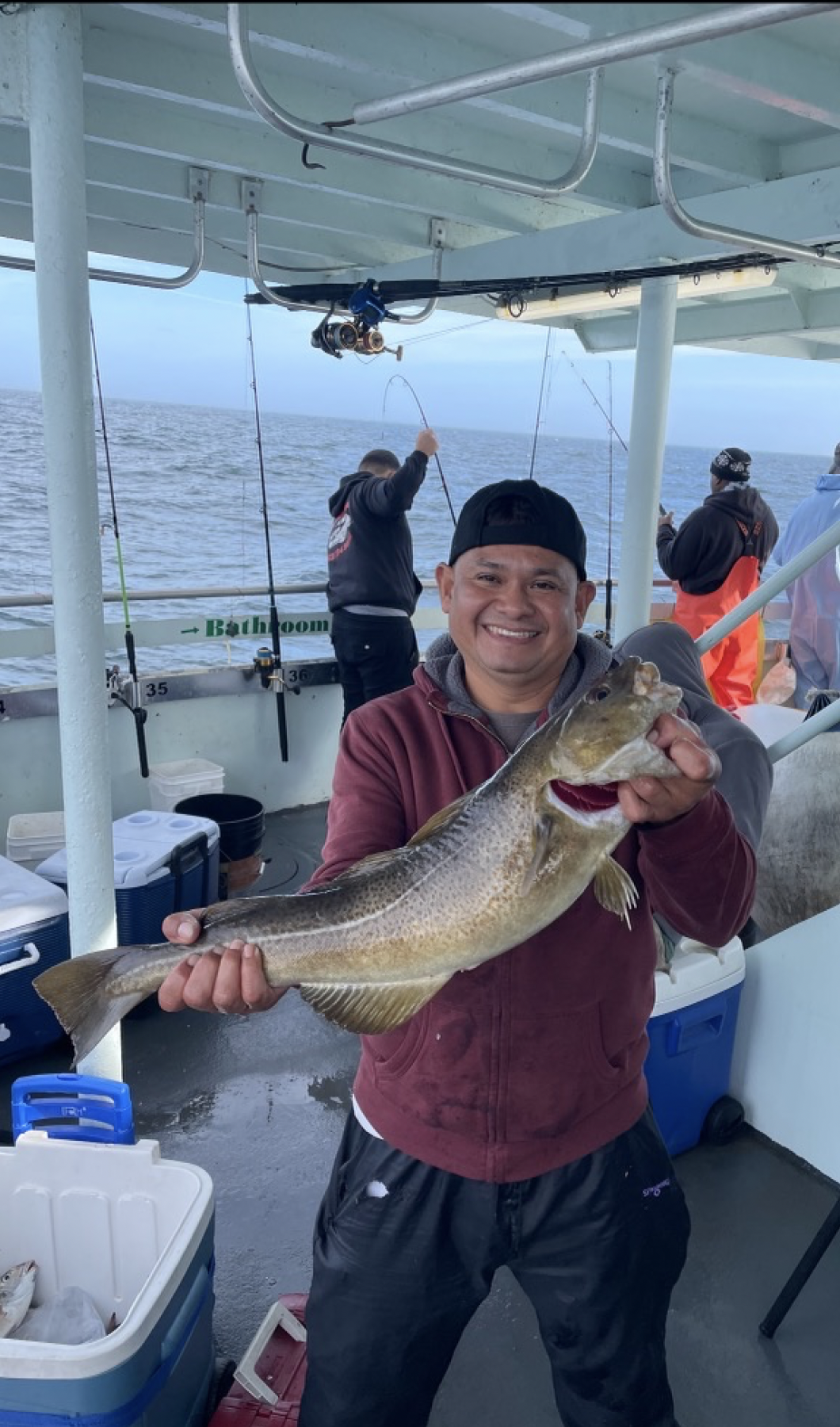 a person holding a fish on a boat