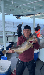 a person holding a fish on a boat
