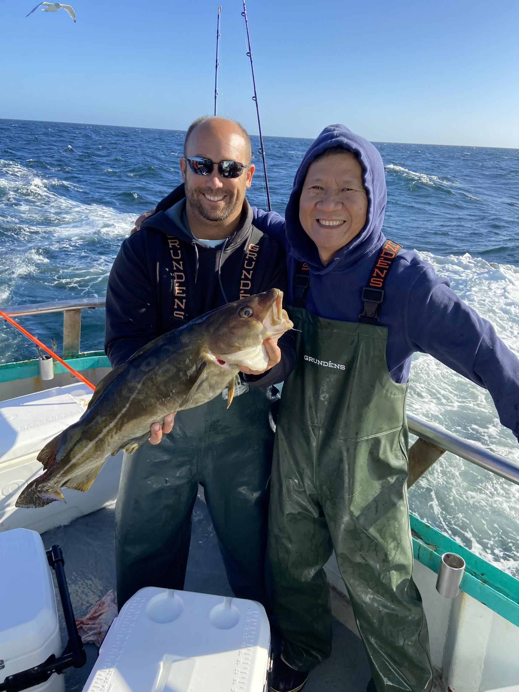 a person holding a fish in the water