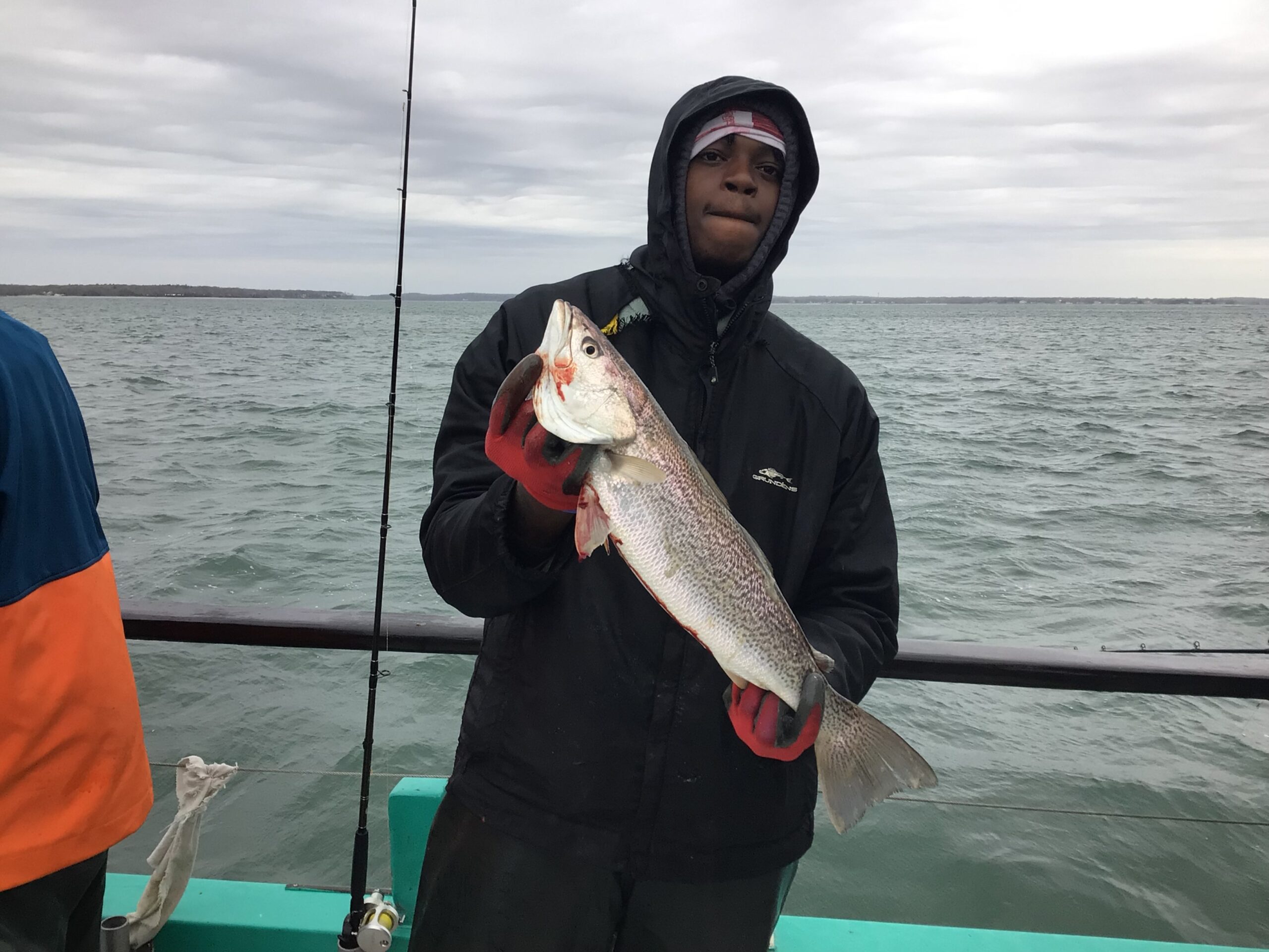 a man holding a fish in the water