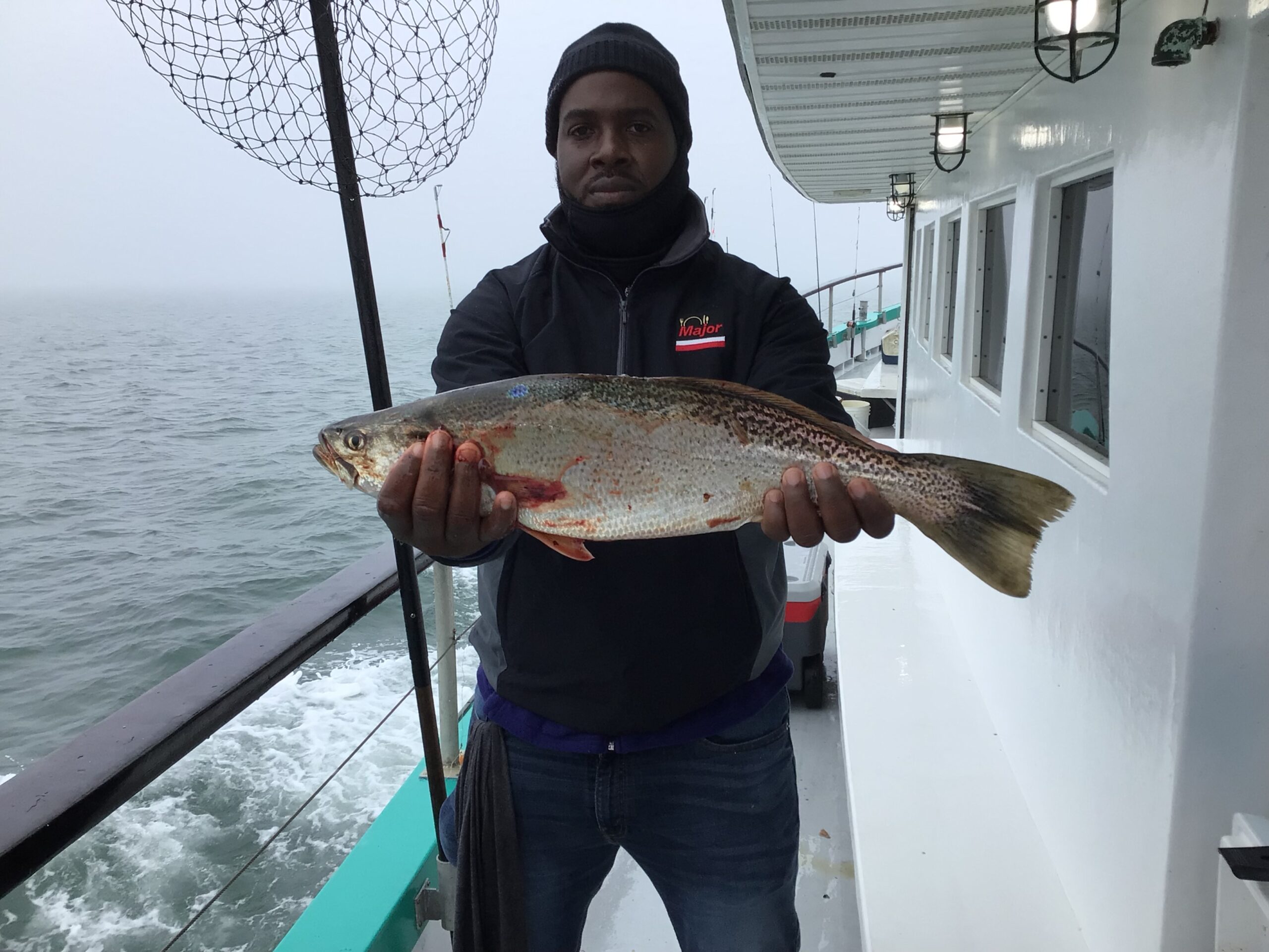 a person holding a fish in the water