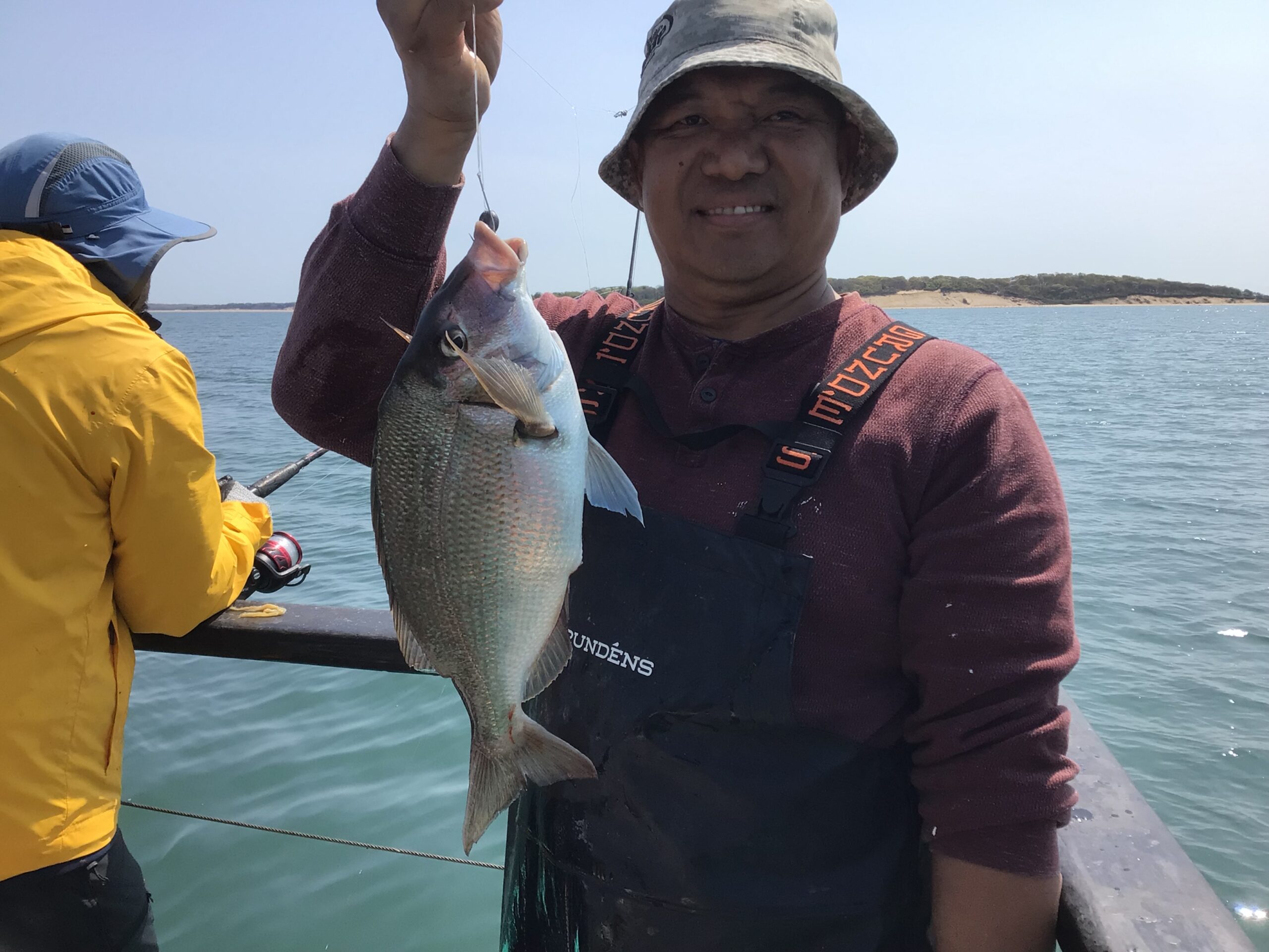 a man holding a fish in the water