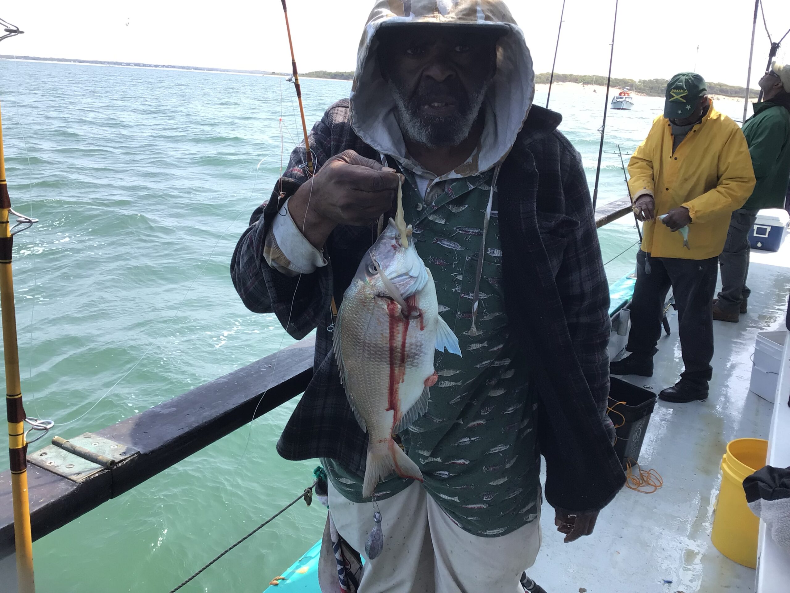 a man holding a fish in the water