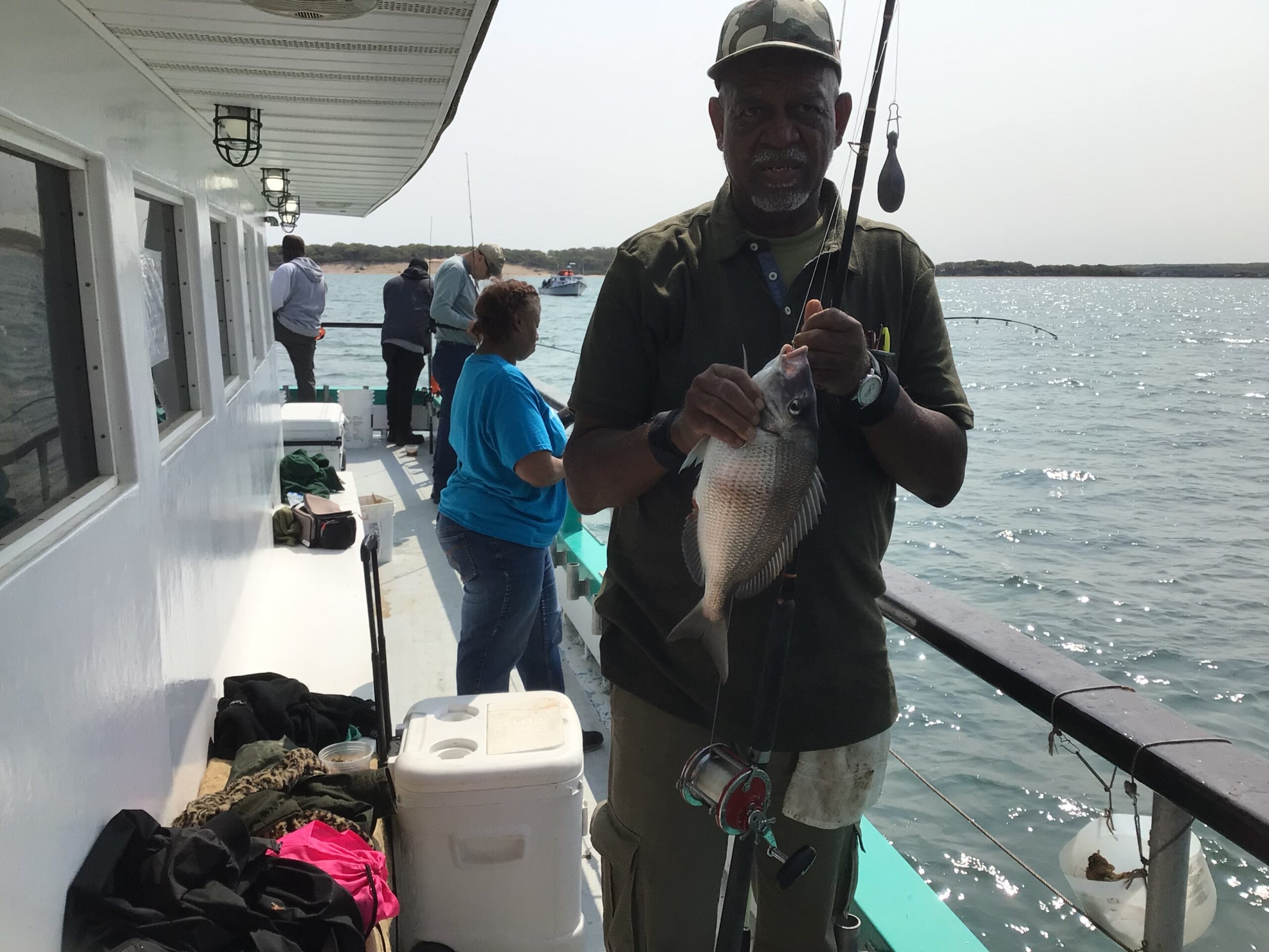 a man holding a fish in the water