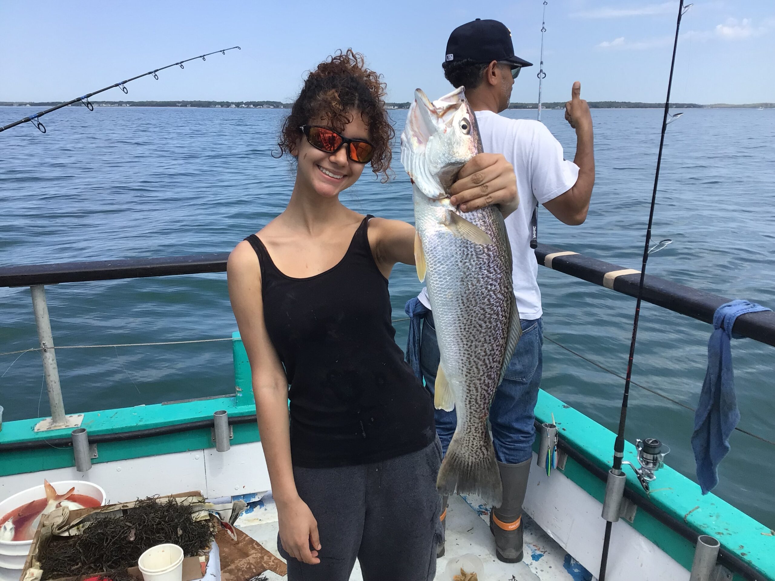 a man and a woman standing next to a body of water