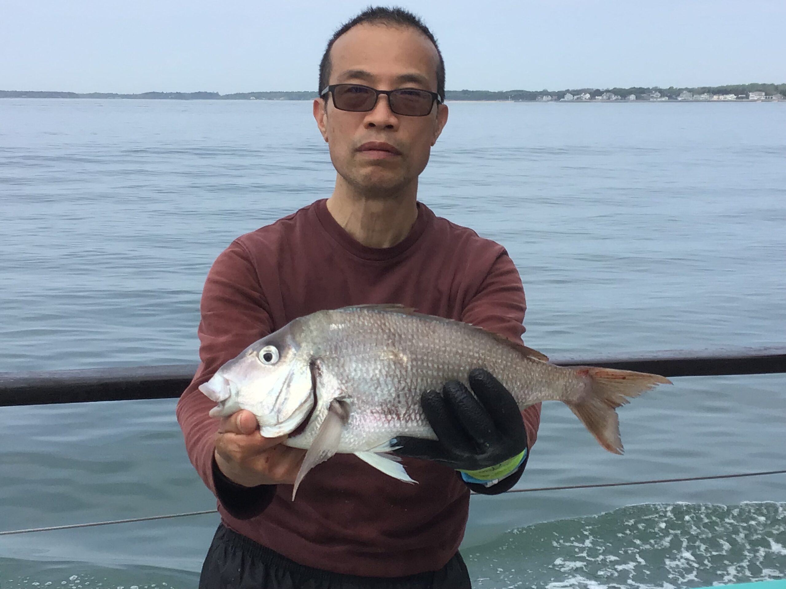 a man holding a fish swimming under water