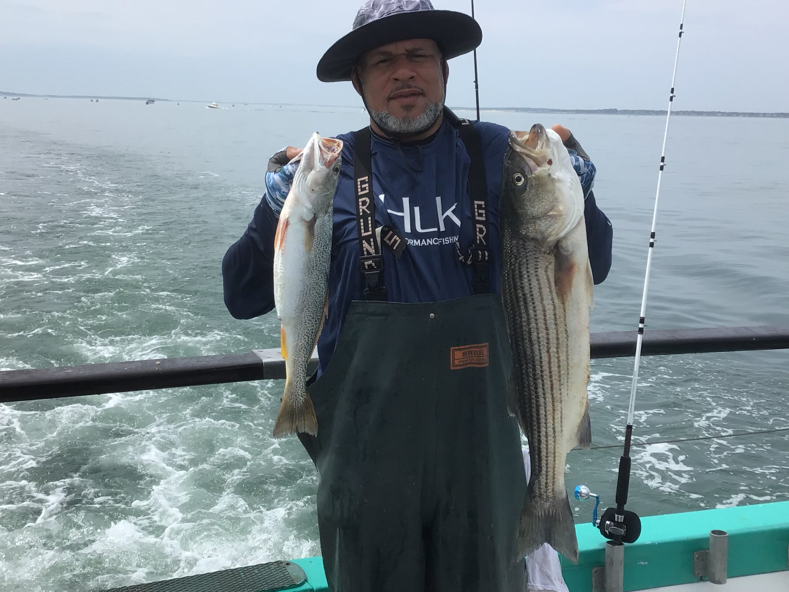 a person holding a fish on a boat in a body of water