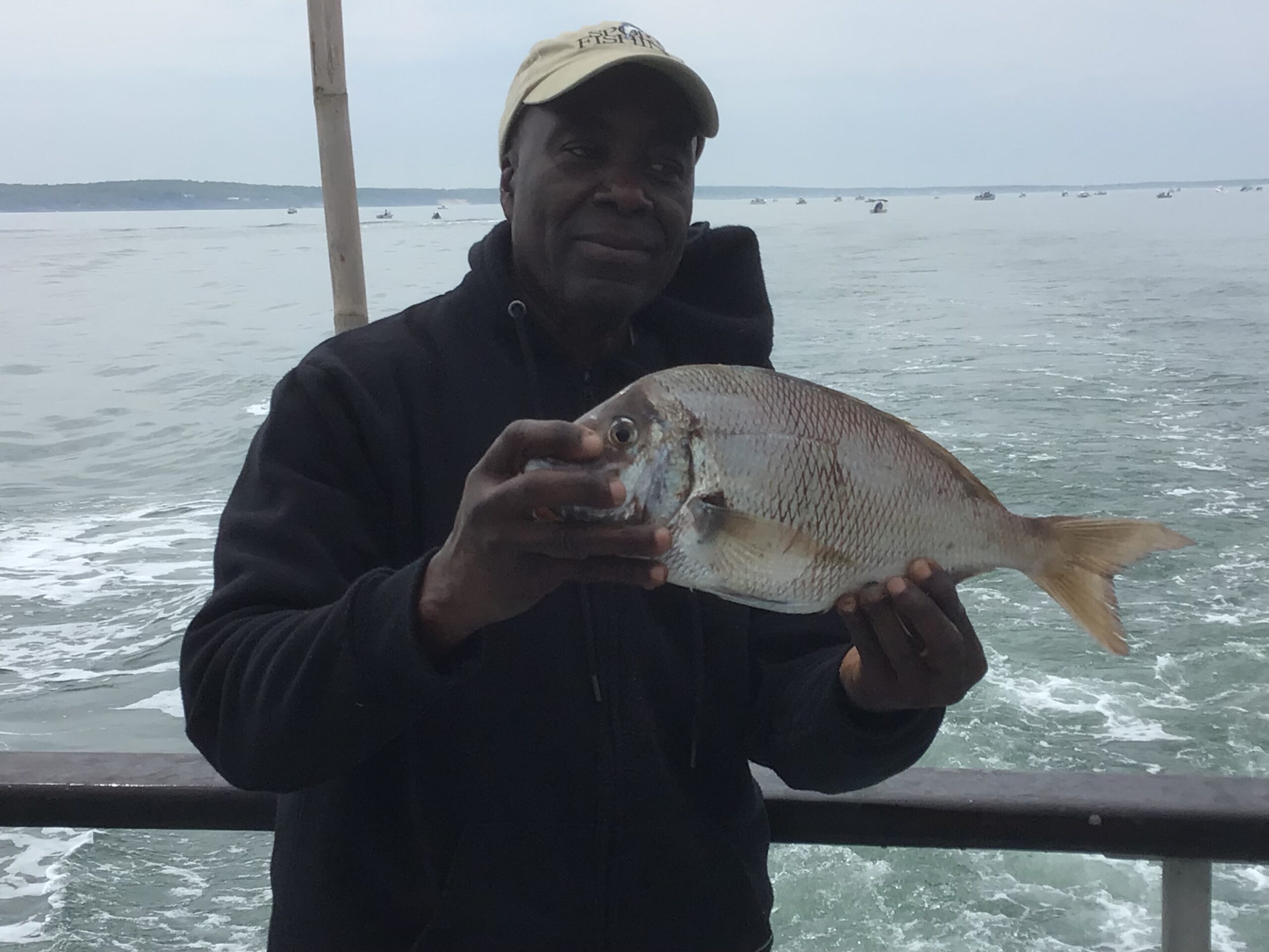 a man holding a fish in the water