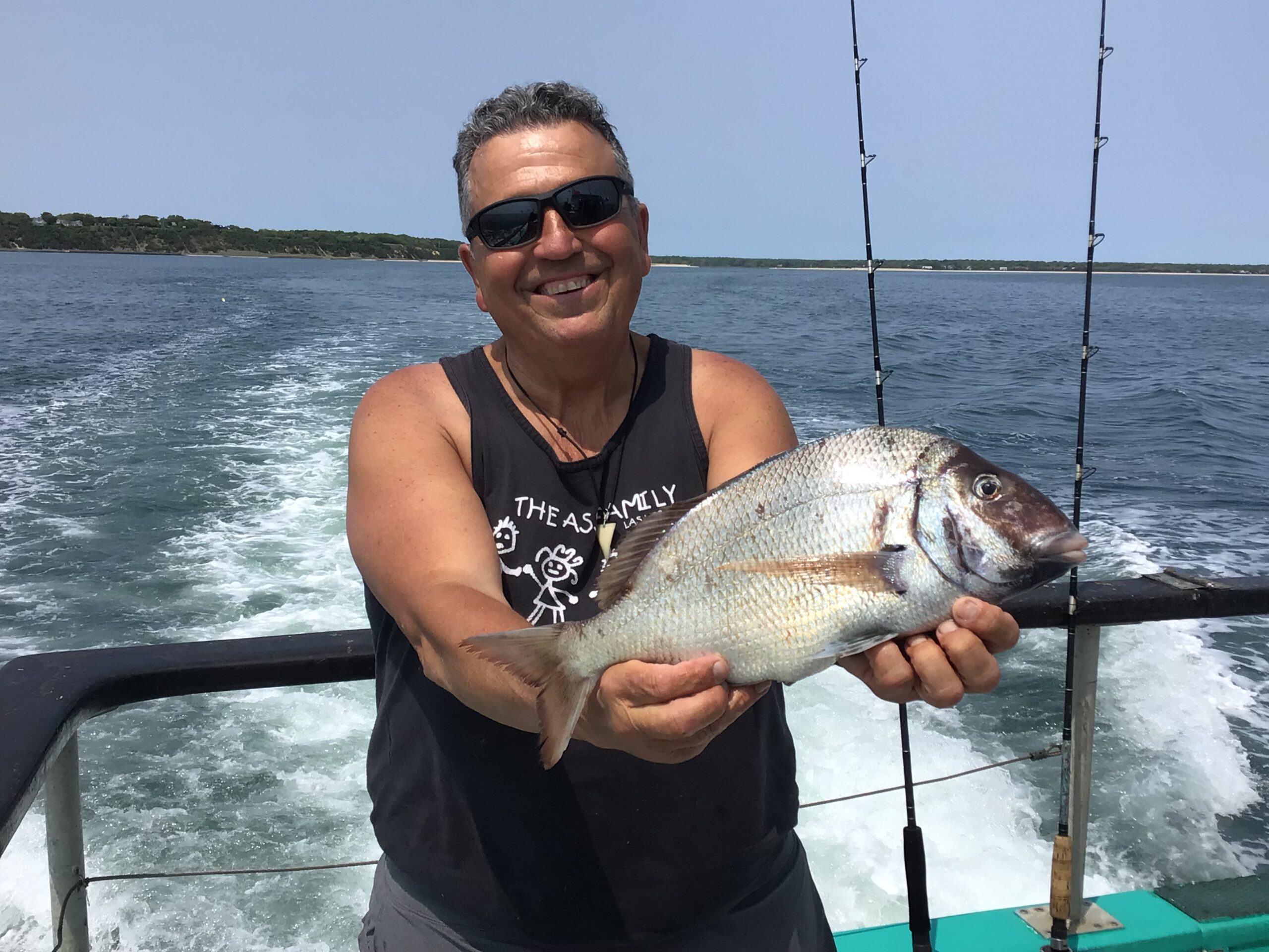 a person holding a fish in the water