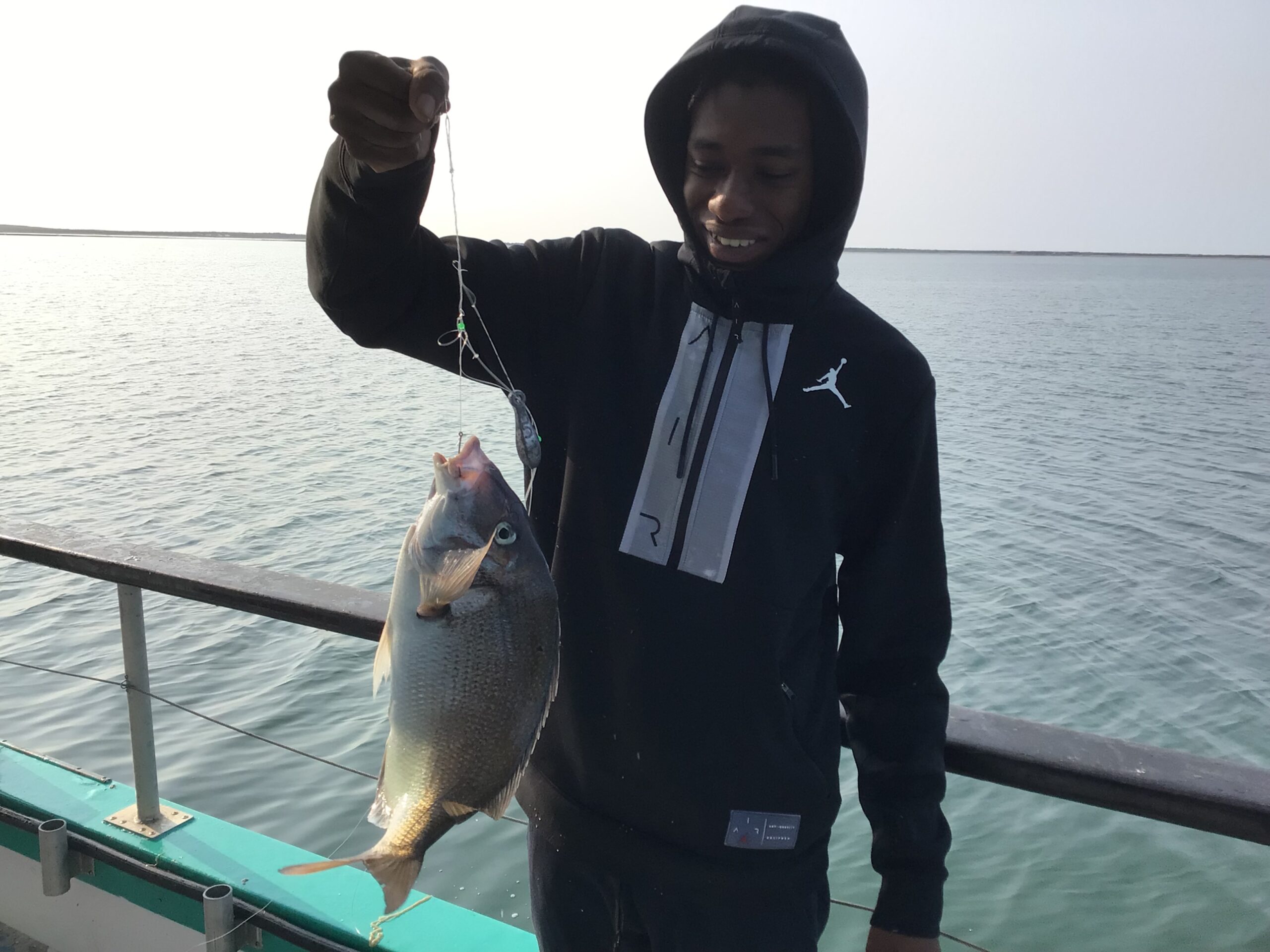 a man holding a fish in the water