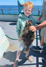 a little boy that is standing in the water