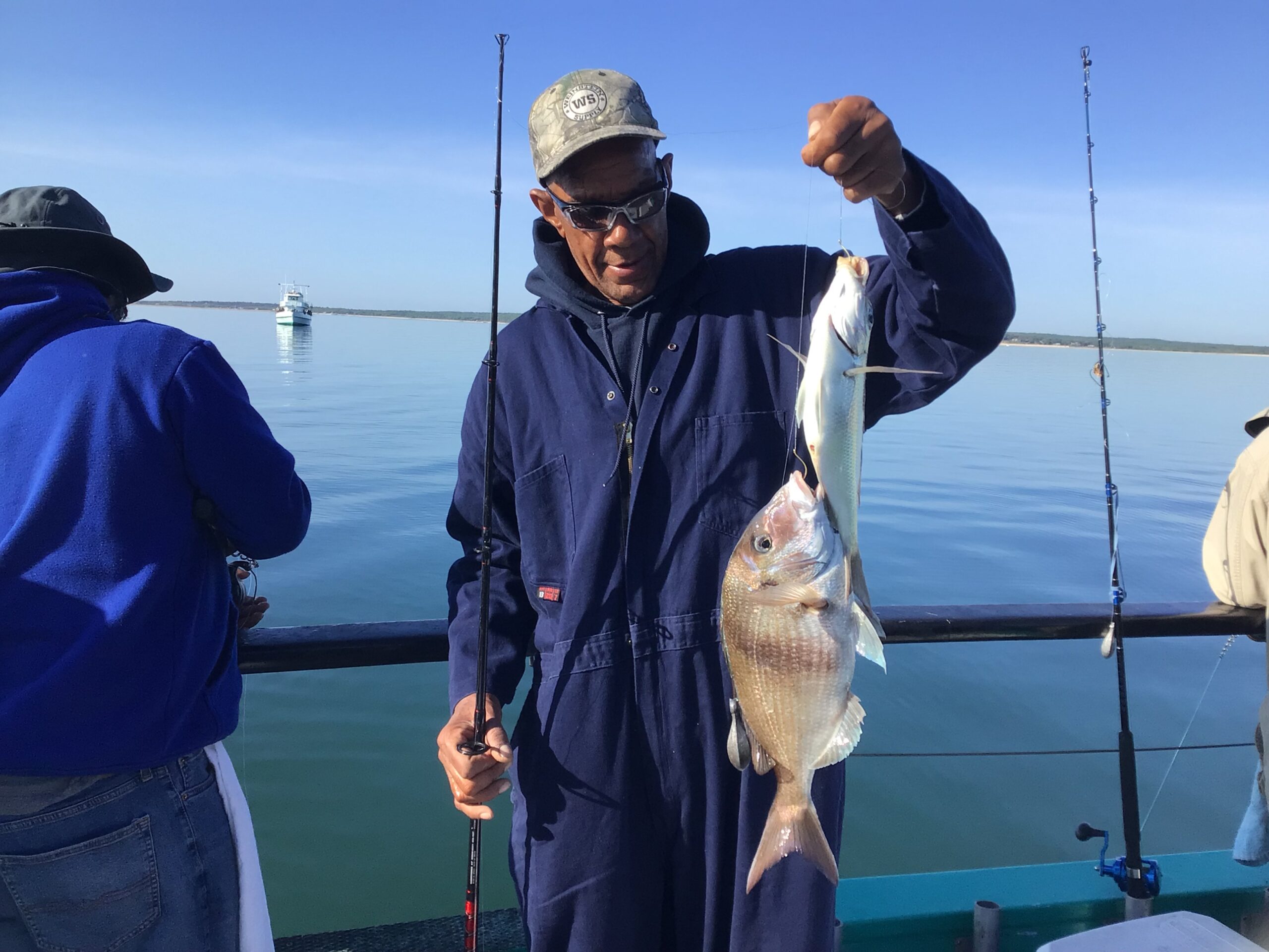 a person holding a fish in the water