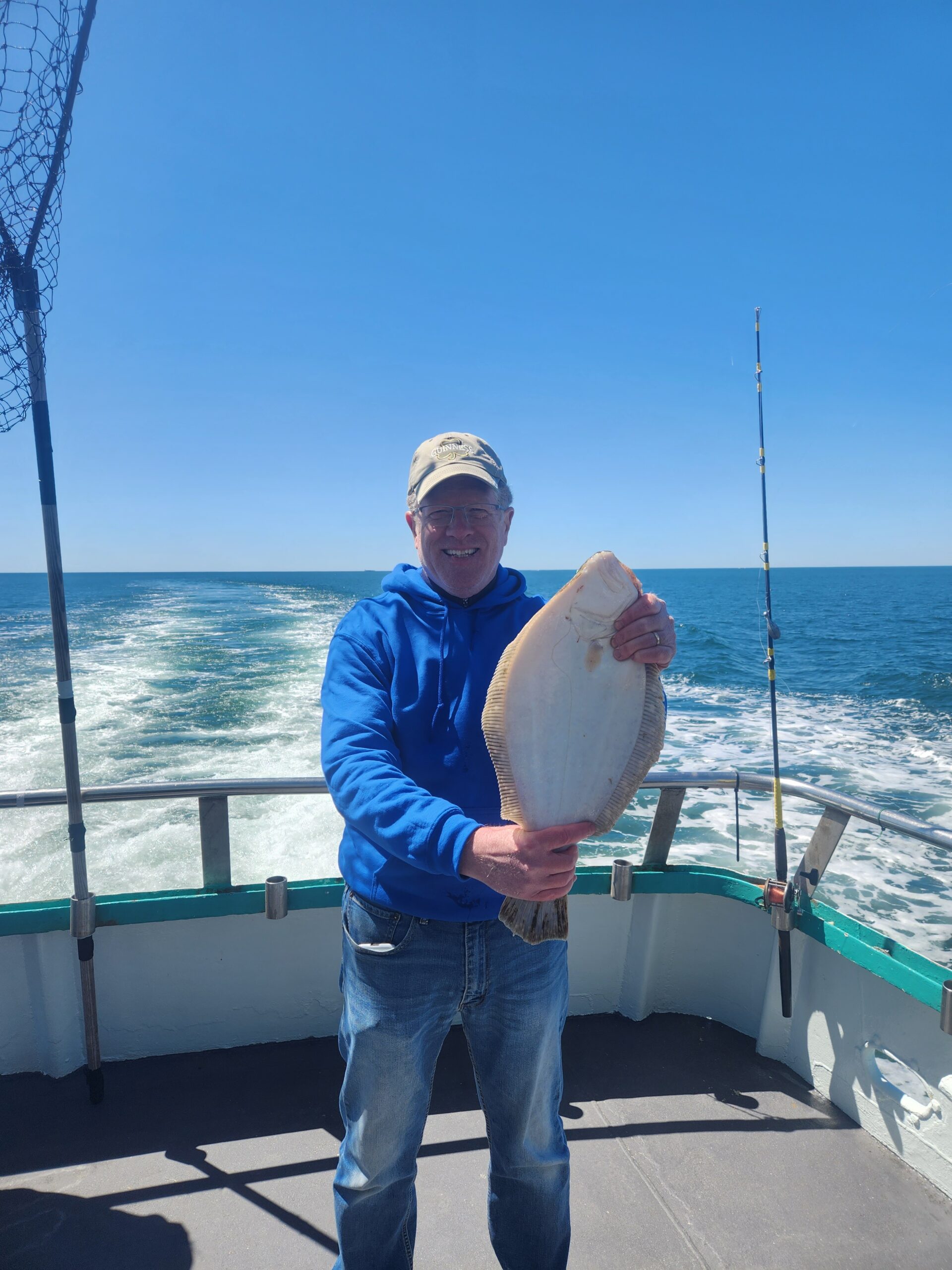 a man holding a fish in the water
