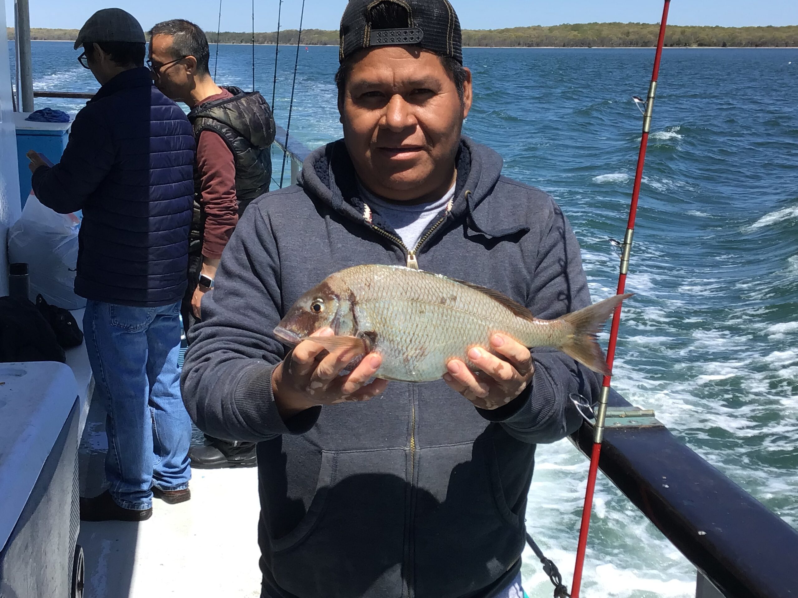 a man holding a fish in the water