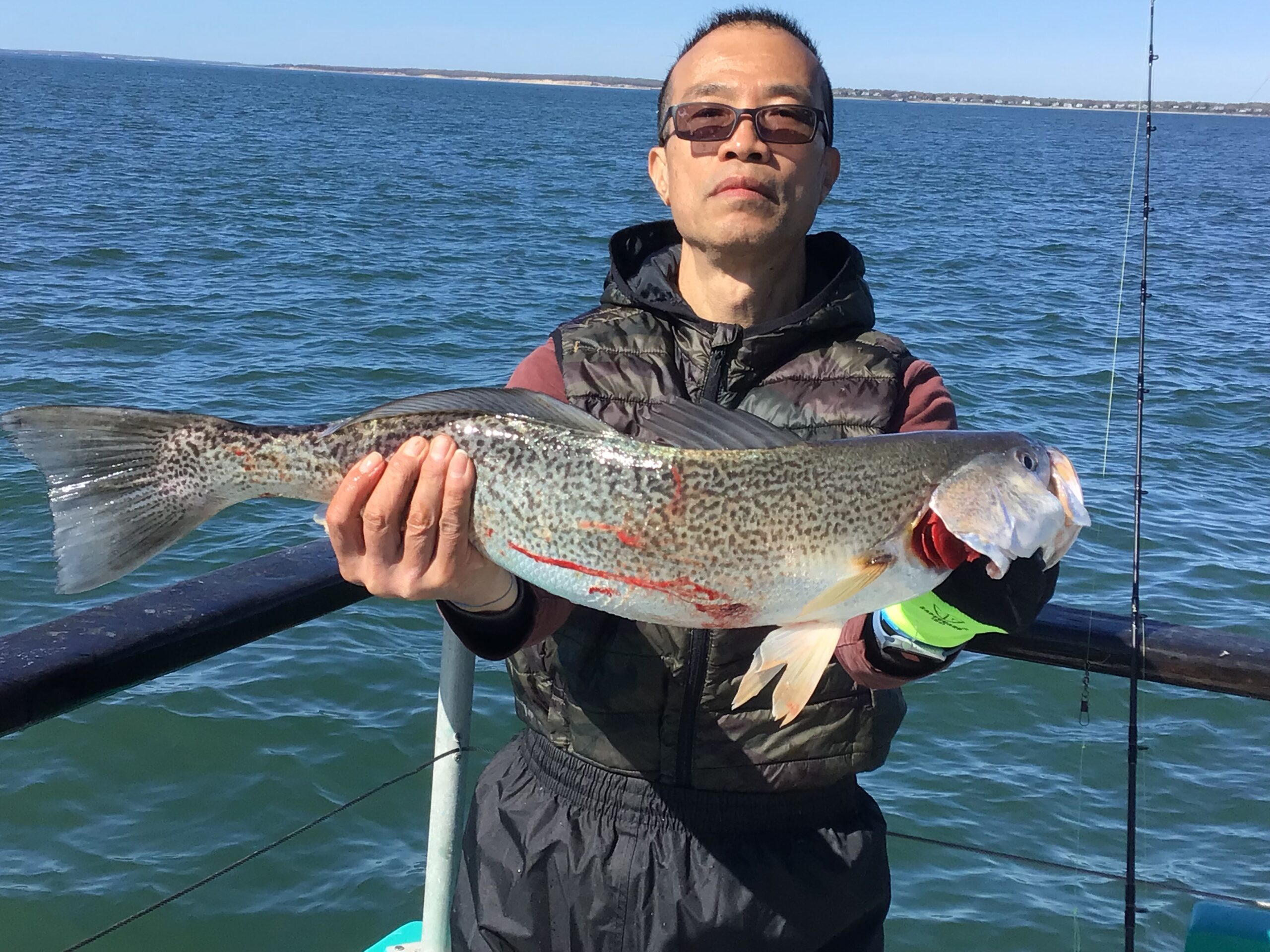 a man holding a fish in the water