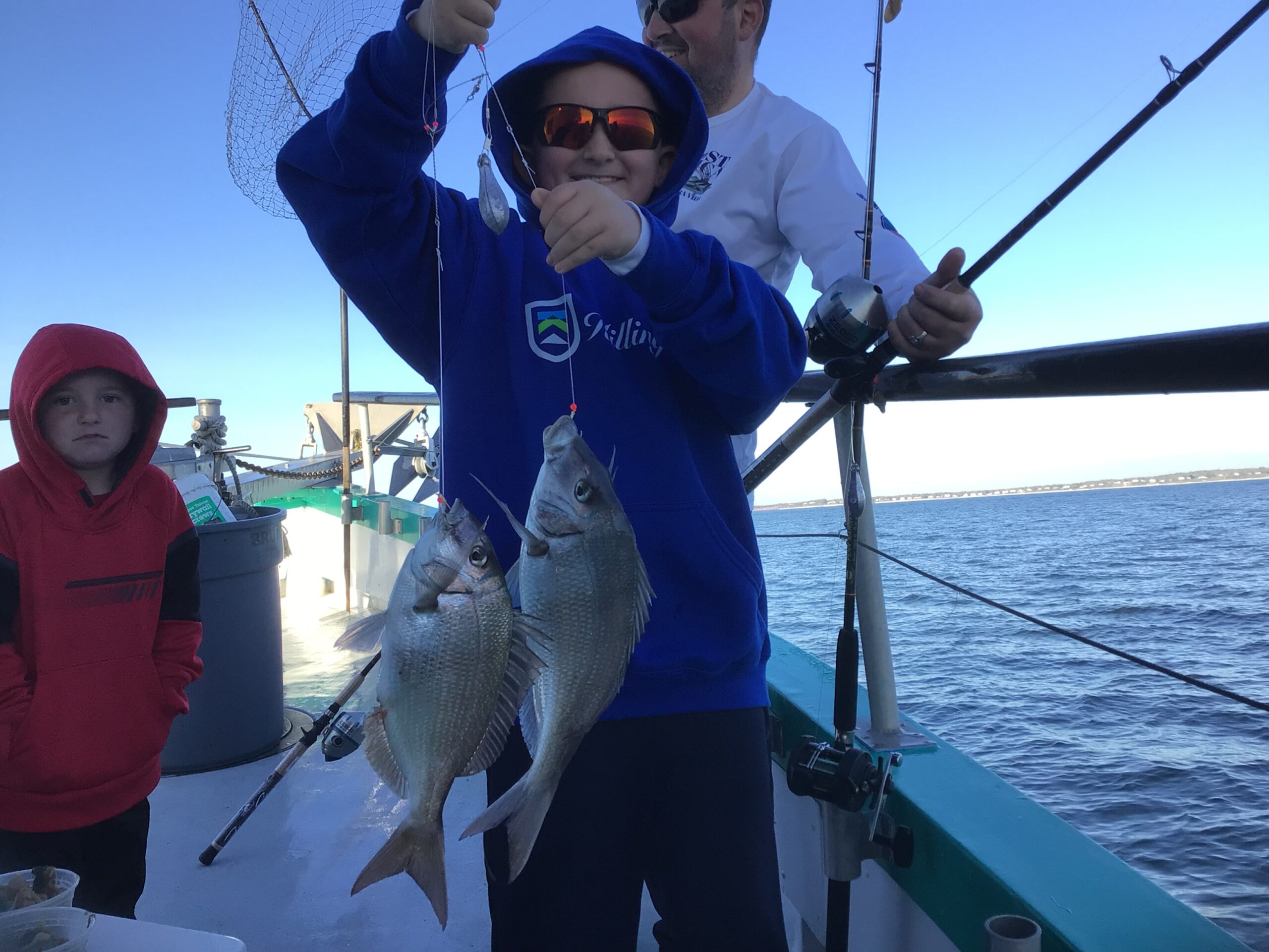 a person holding a fish on a boat