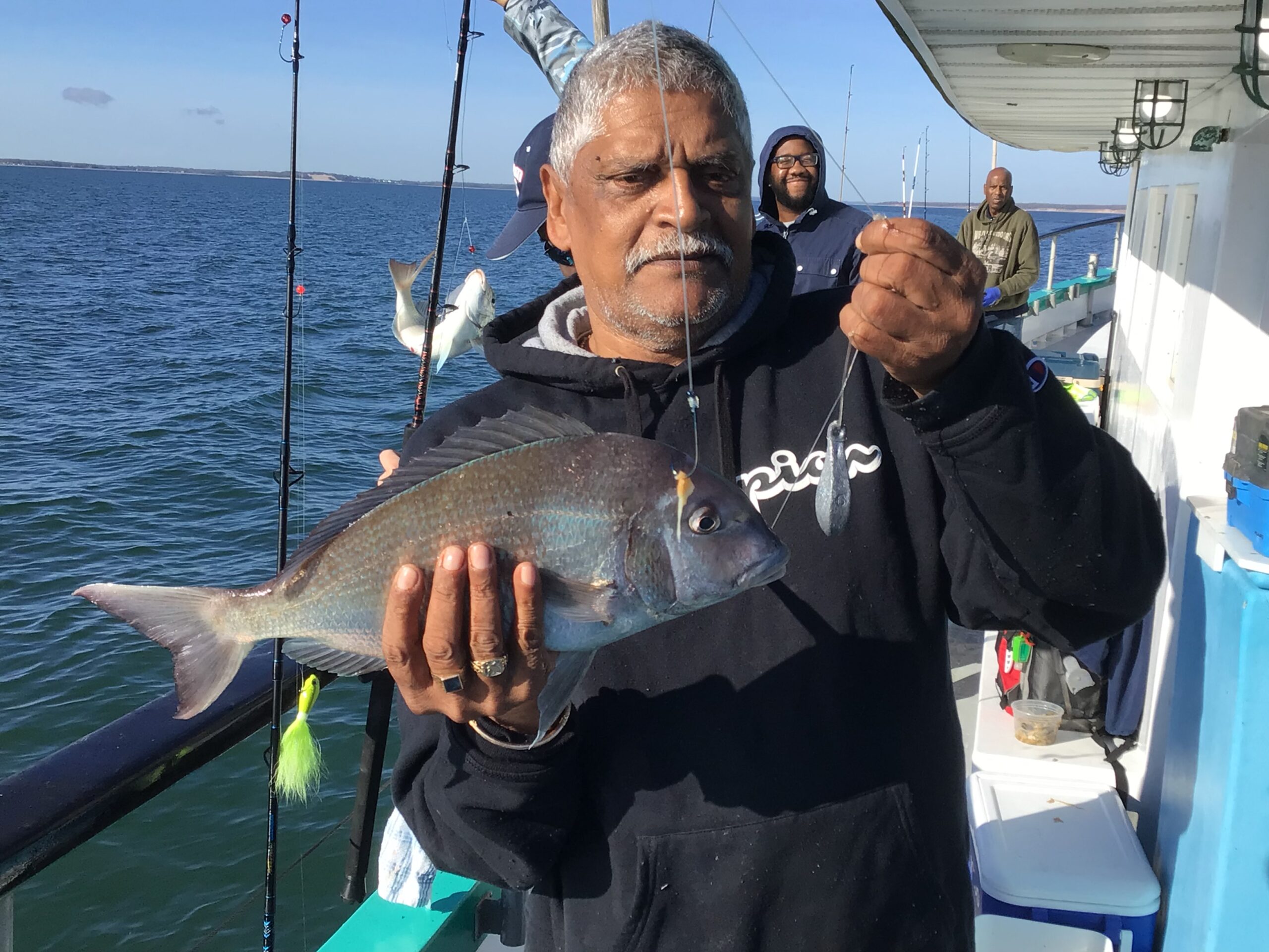 a man holding a fish in the water