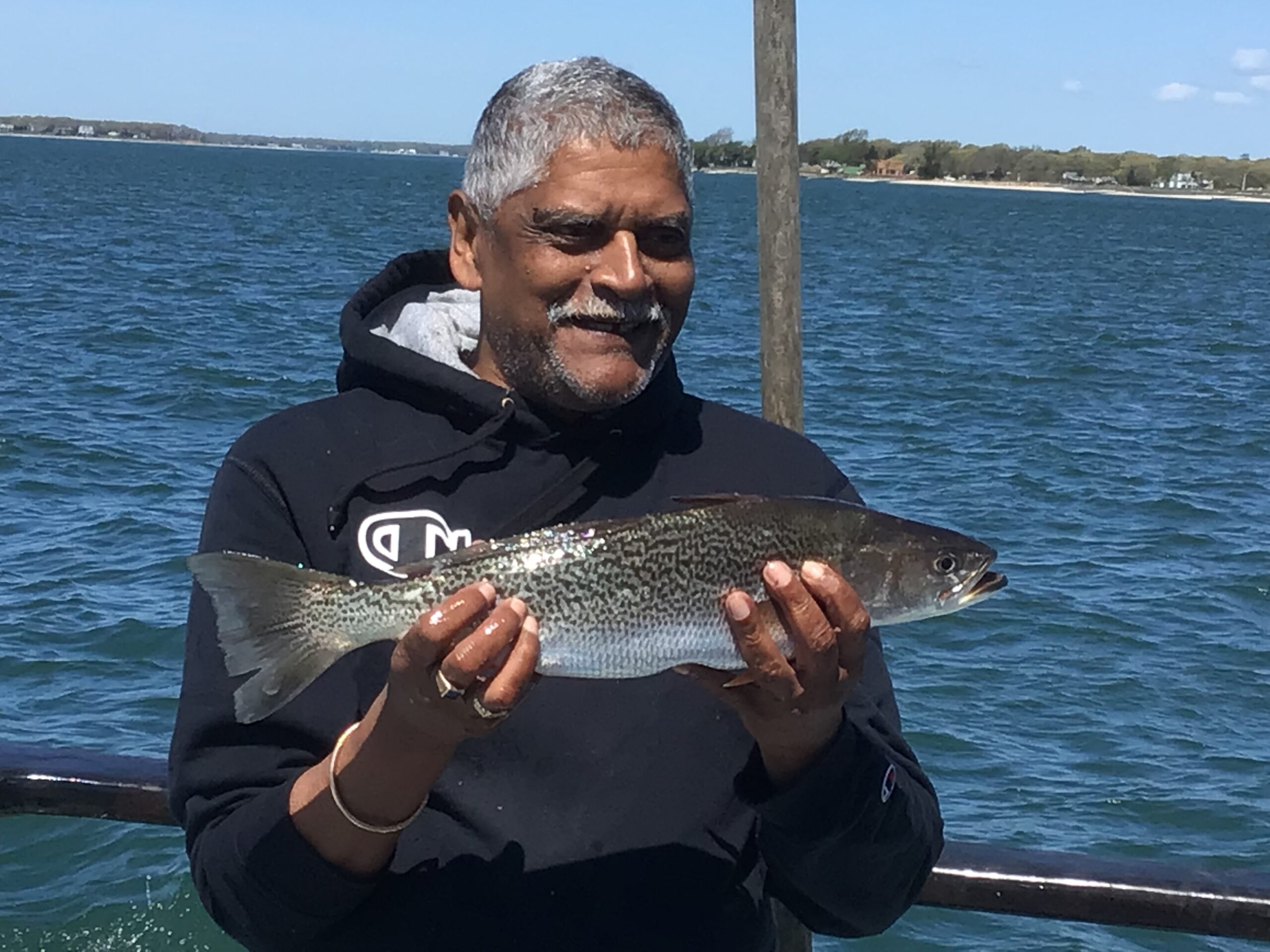a man holding a fish in the water