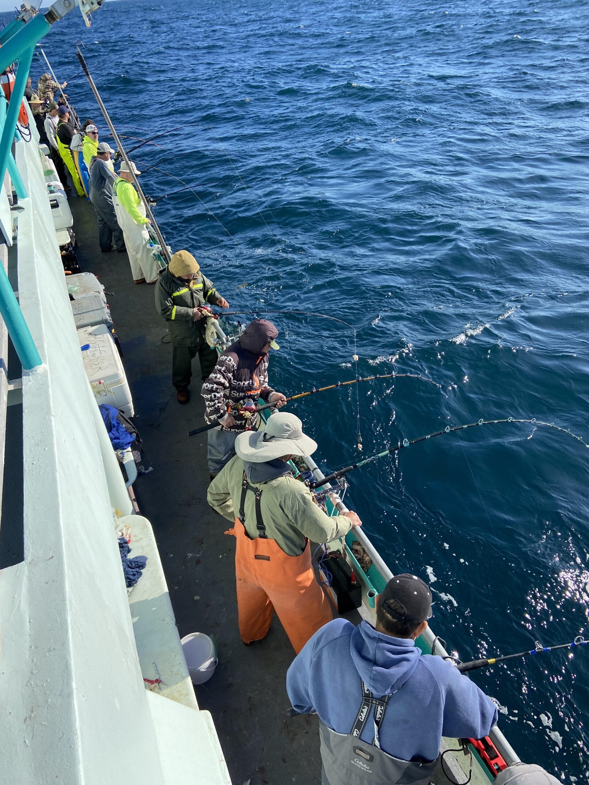 a group of people standing next to a body of water