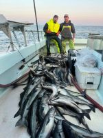 a man holding a fish on a boat