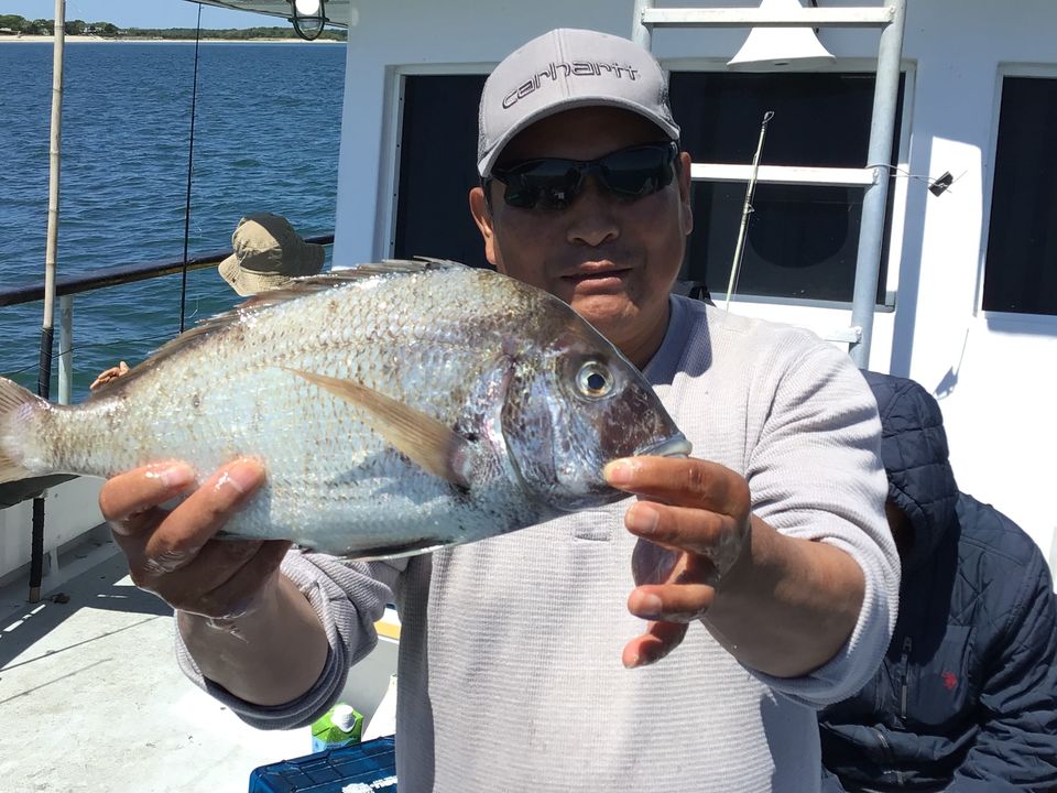 a man holding a fish in the water