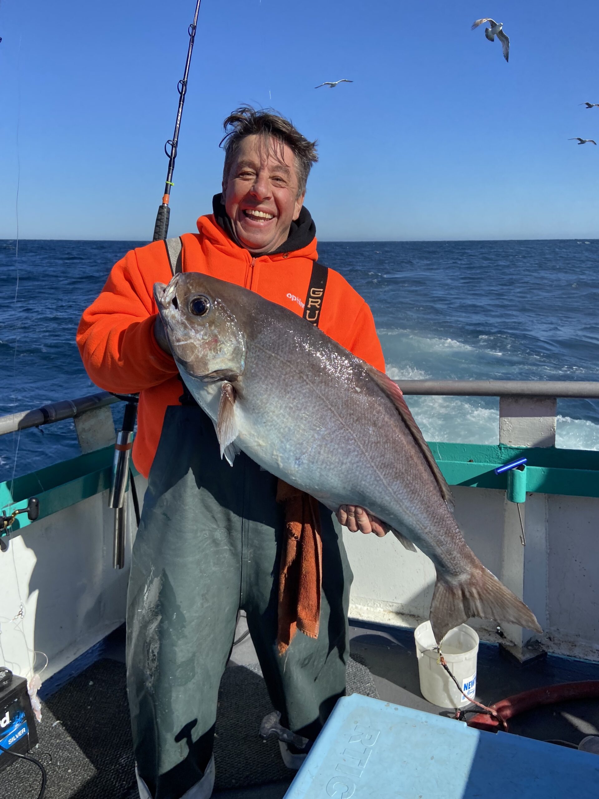 a person holding a fish in the water