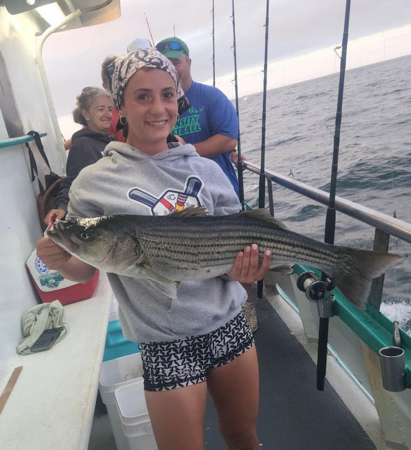 a young boy holding a fish