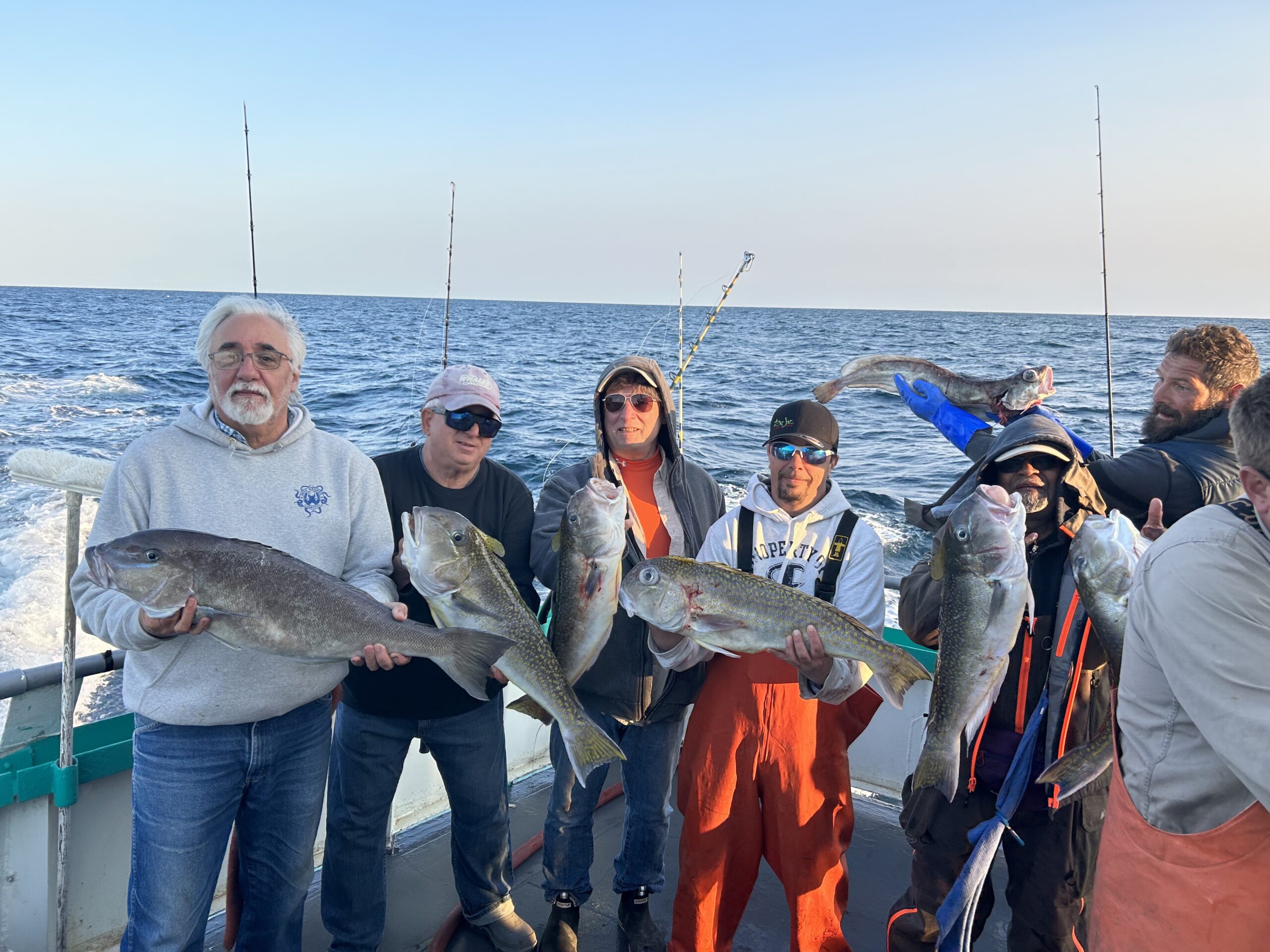 a group of people standing next to a body of water