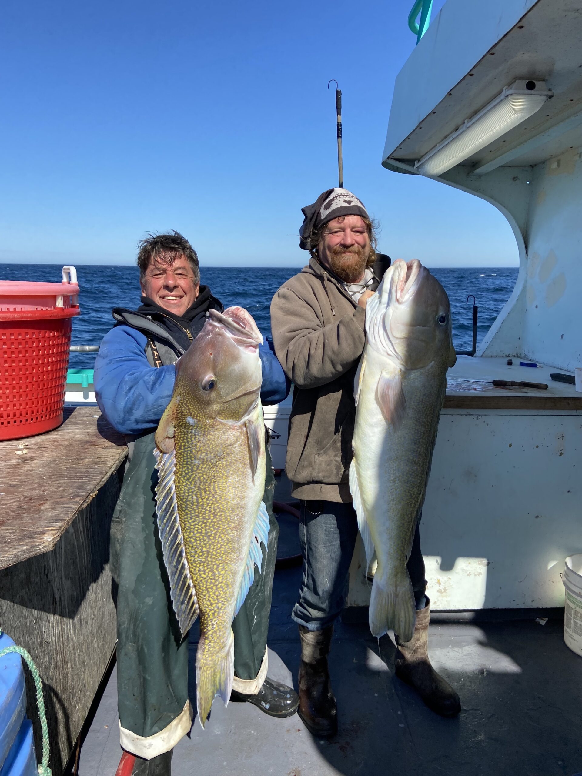 a person holding a fish on a boat