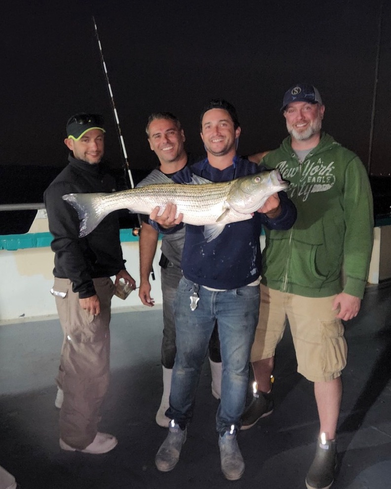 a man holding a fish