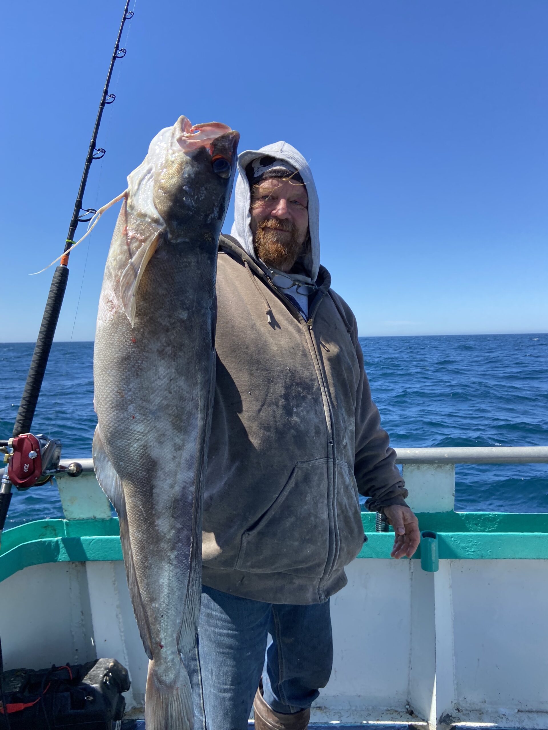 a man holding a fish in the water