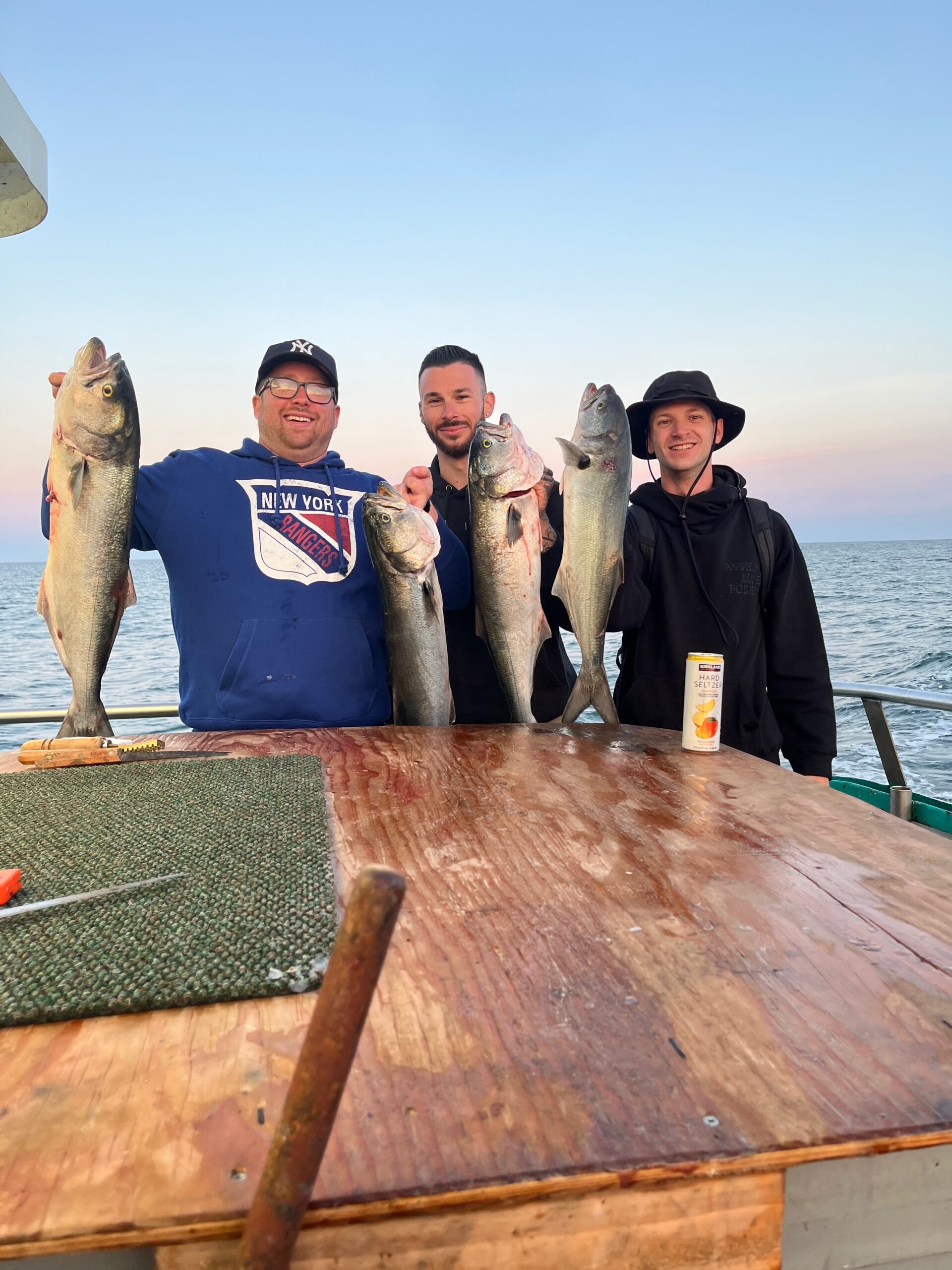a group of people standing on top of a wooden boat