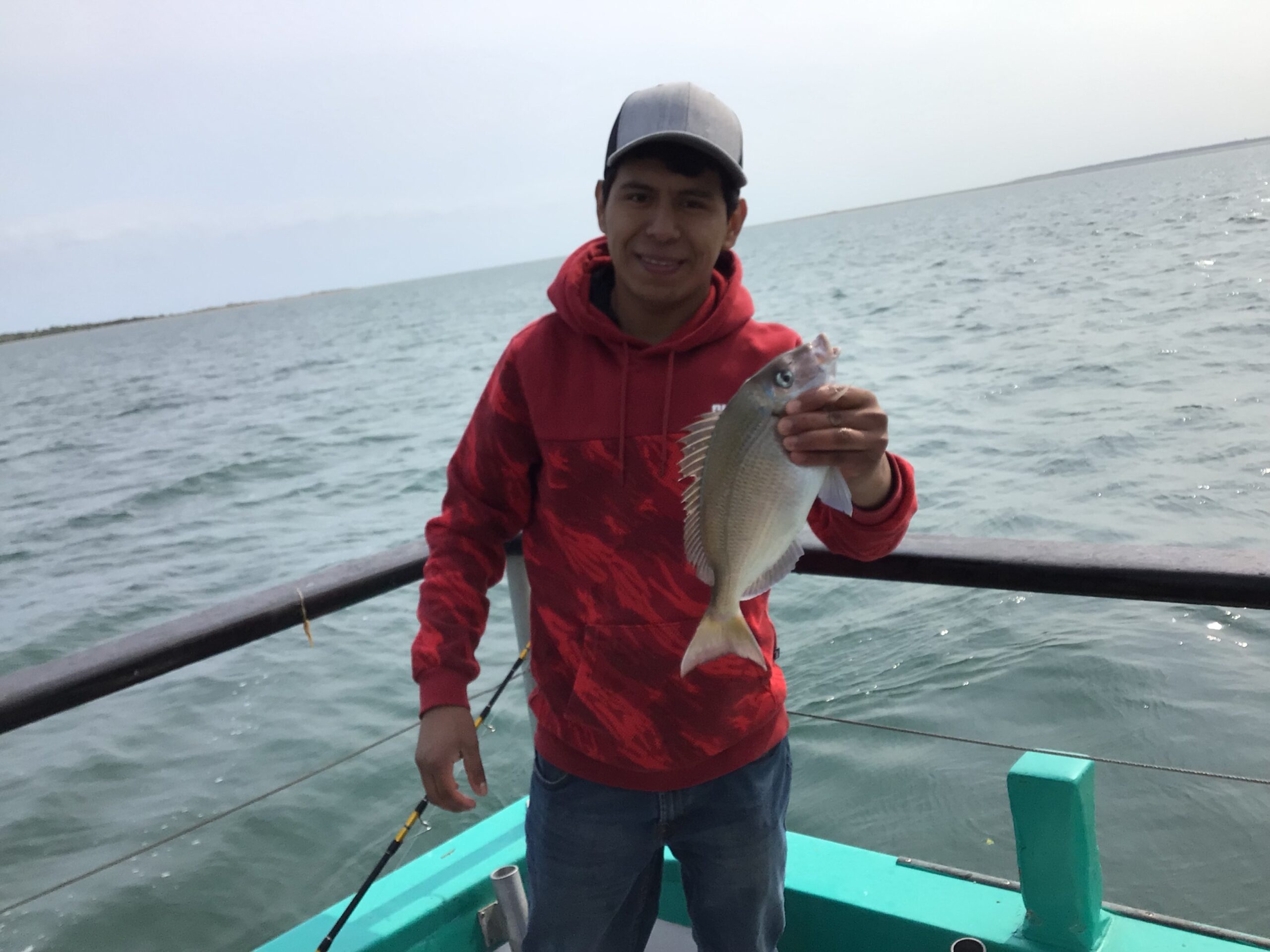 a man standing next to a body of water