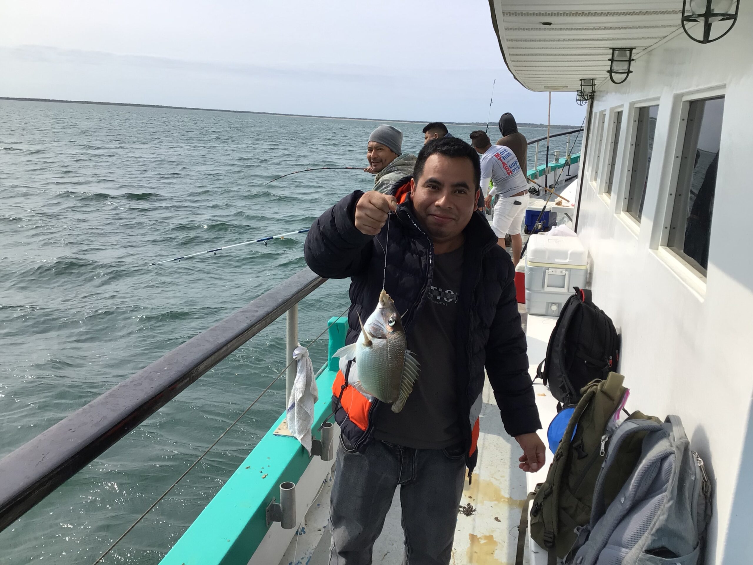 a man and a woman standing in front of water