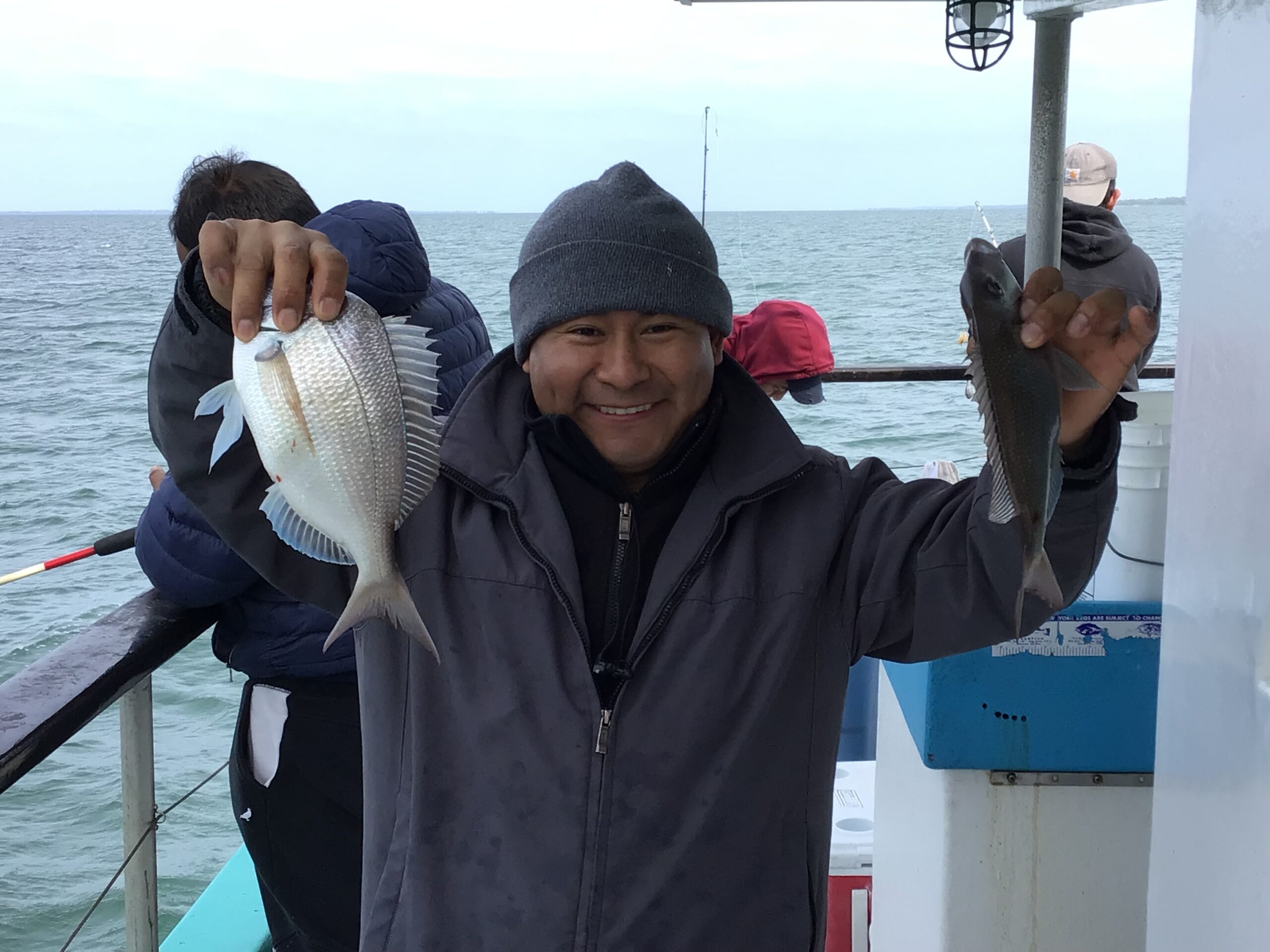 a couple of people standing next to a body of water