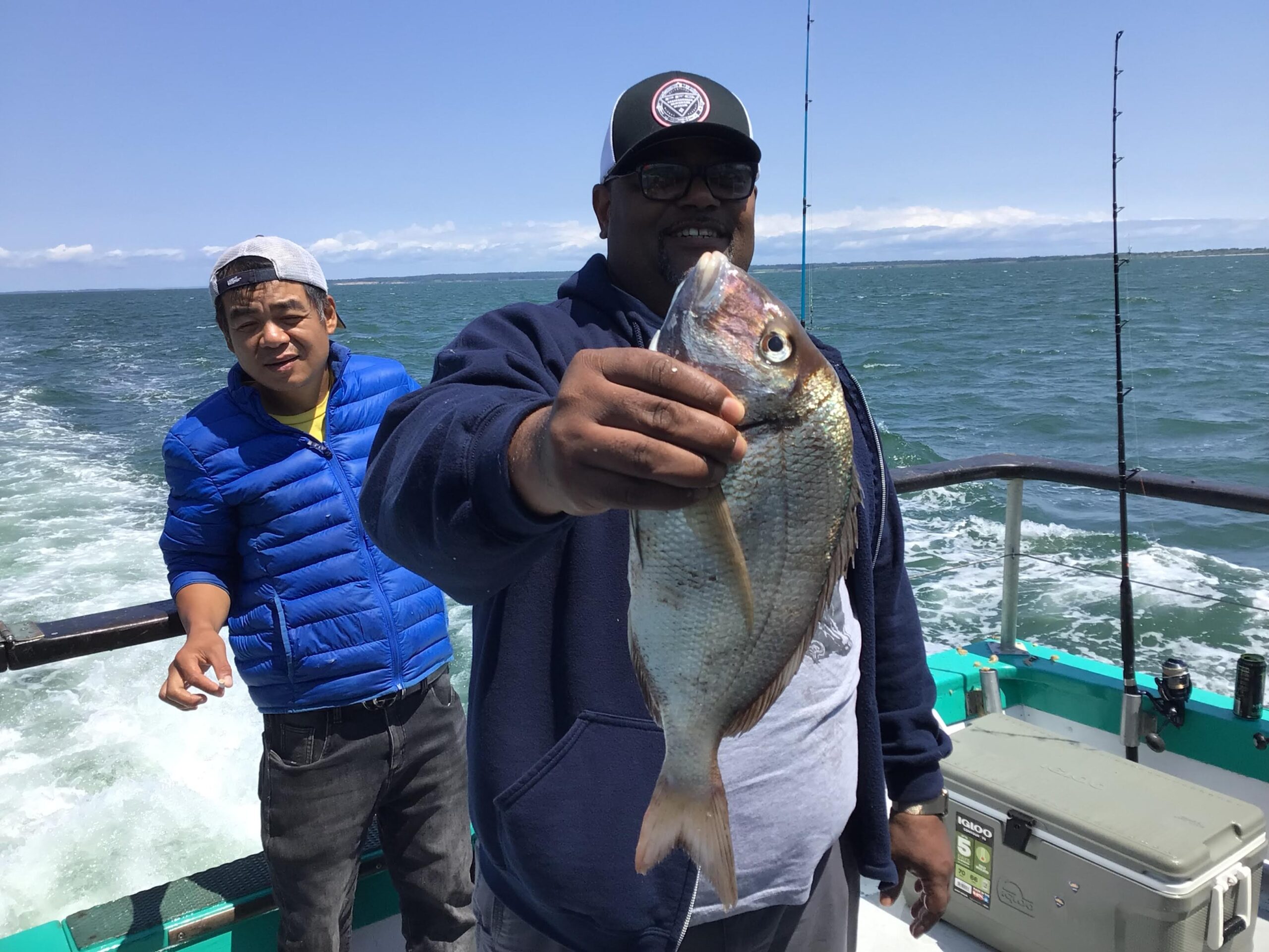 a person holding a fish in the water