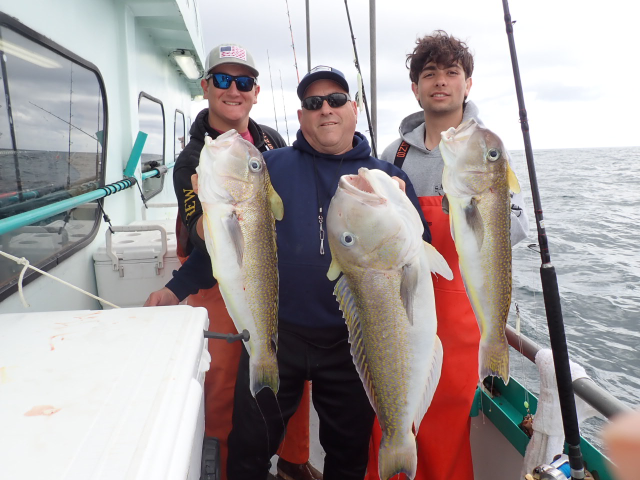 a person holding a fish on a boat