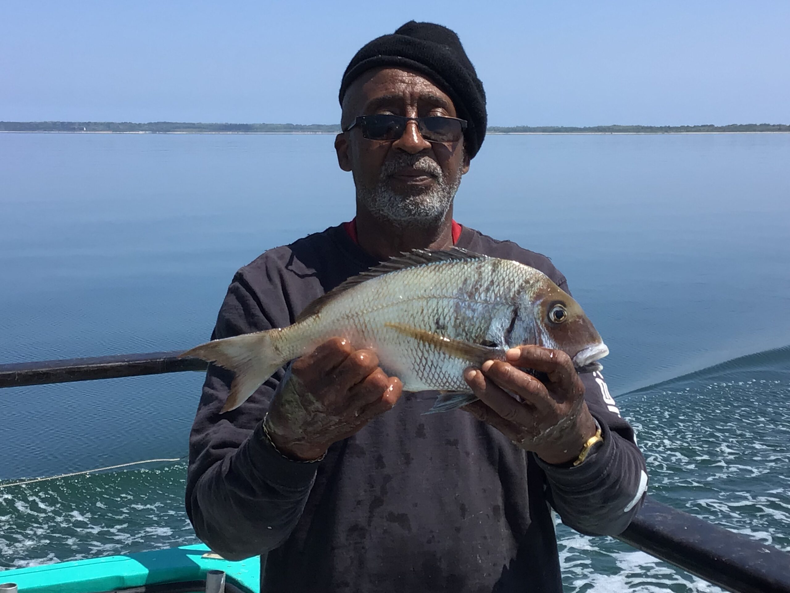 a man holding a fish in the water