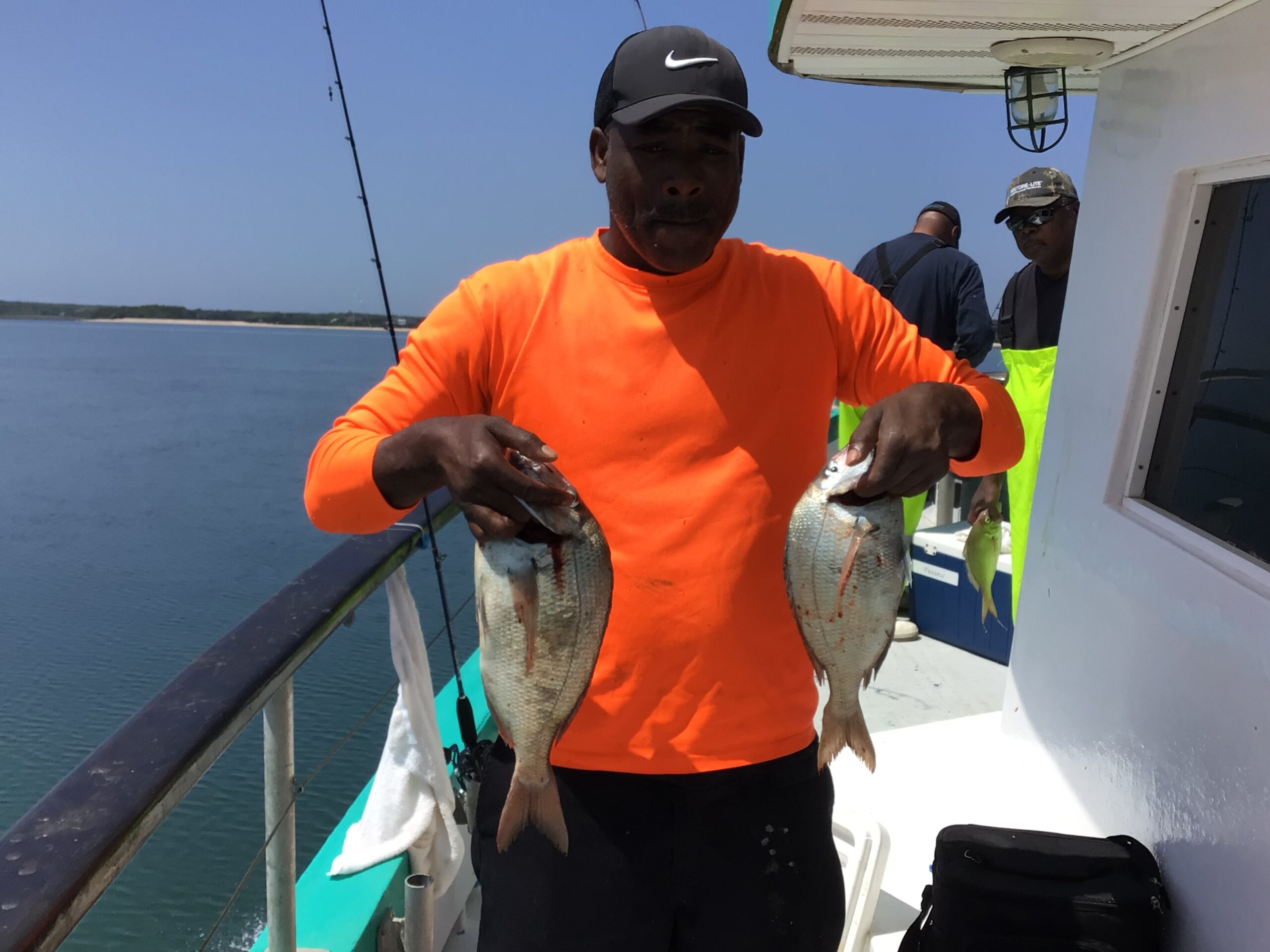 a man holding a fish in the water